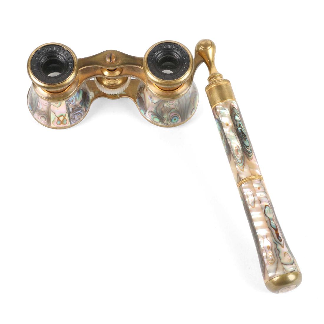 Chevalier Opera Glasses: French. 1920s. Chevalier. Inner eyepiece bakelite embossed, "Chevalier Opticien Paris". 4" x 7" x 2". Mother of pearl intact. Extension handle is loose.