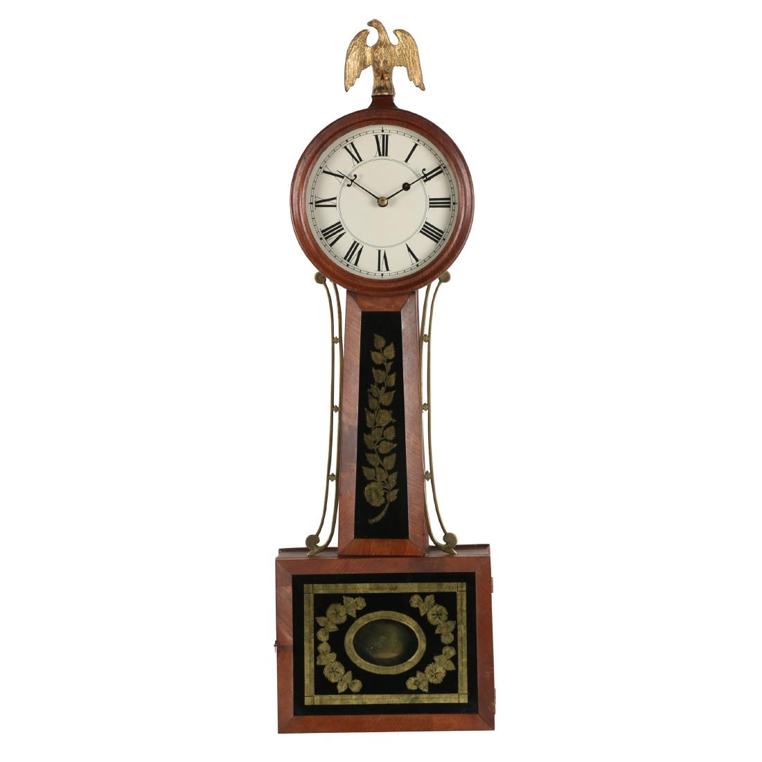 American Weight-driven Banjo Clock: American. Early weight-driven banjo clock. Typical American form. 29" x 10" x 3.75". Clean and complete. Retains original eagle finial and winding key. Replacement glass and dial. Case refinished. Ori