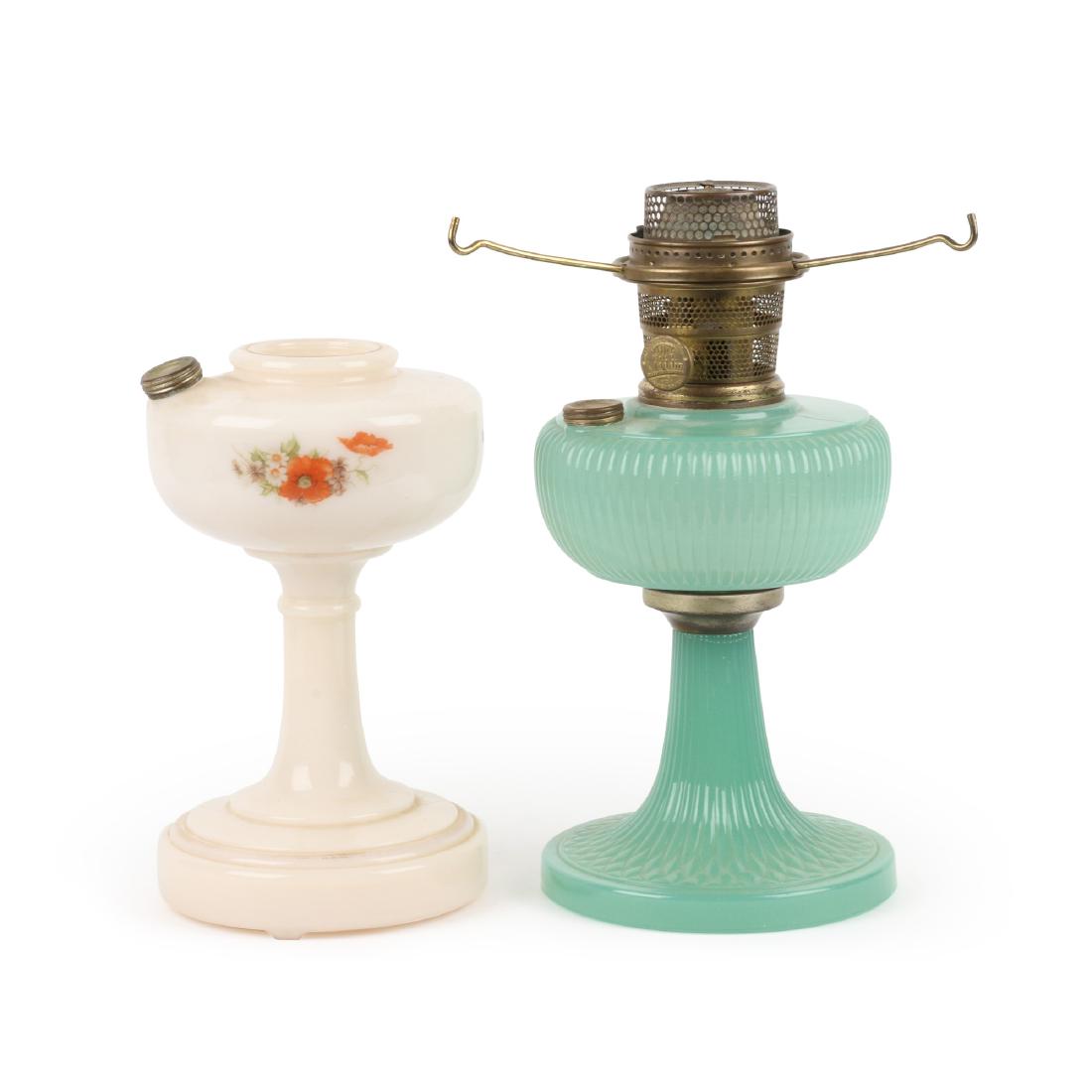 Vertique & Decalcomania Aladdin Lamps: Two (2). Jadite Vertique model with rare "Decalcomania" model. "MANTLE LAMP CO NU-TYPE Model B Aladdin PATENTS PENDING MADE IN USA CHICAGO IL". 9" x 16" x 13". 4kg. No chips or cracks. Complete with "