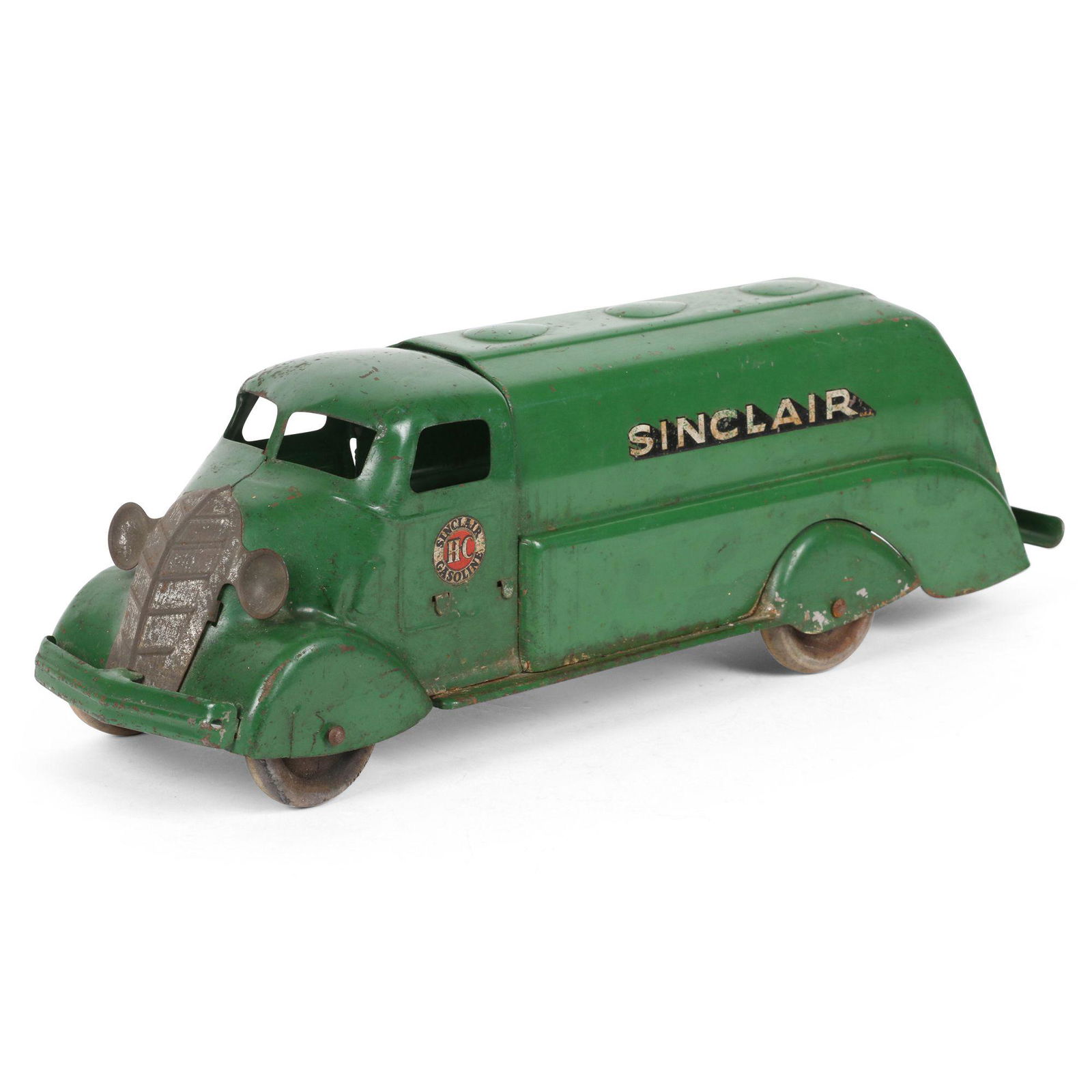 Sinclair Toy Oil Tanker: American. Pressed steel, wood wheels. 18" x 5" x 5". Surface scuffs at edges. Decals exhibit uniform loss. Grille has lost its silvered finish. All original paint and decals. Est. $200 - 300