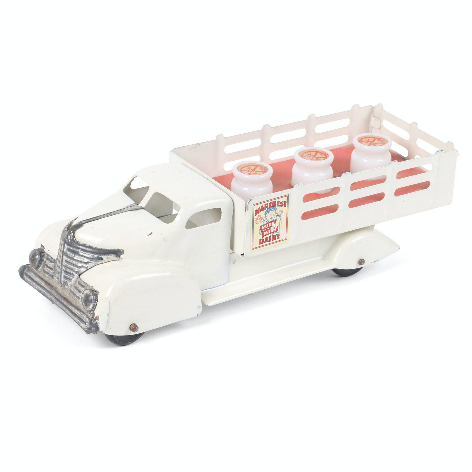 Marx "Marcrest" Dairy Delivery Truck Toy: 14" x 5" x 4". American. Circa 1940s. Minor loss to decal. Retains original glass milk cans with cardboard caps and bed insert. Grille exhibits plating loss. Original surface.