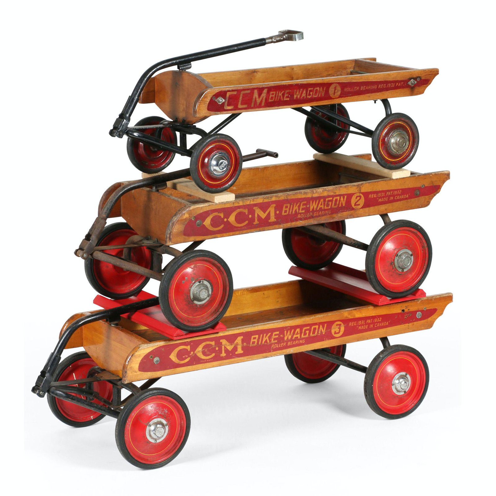 CCM Wagon Set: Three (3). Canadian. 1932. Overall length 47", 40", and 36". Model (1,2 and 3) denotes the capacity (number of children accommodated). Scripted, "CCM Roller Bearing - Reg. 1931 Pat. 1932 - Bike Wagon"