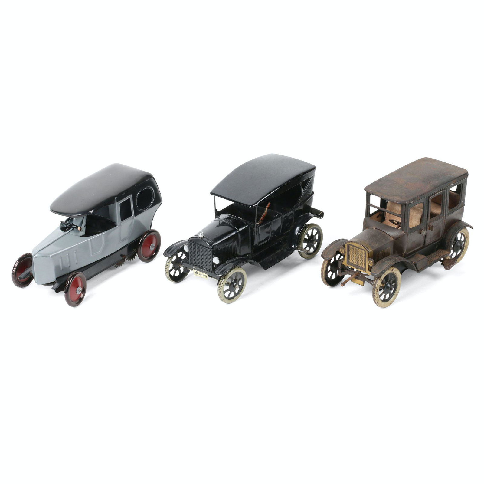 German Wind-Up Tin Car Toys: Three (3). Approximately 6" (l) each. Tin litho. Includes 2 Orobr cars, one restored and another original Model T. Also includes one Bing Model T featuring a lady driver.
