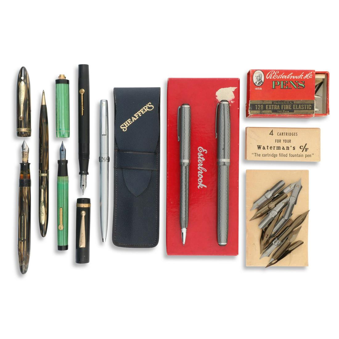 Esterbrook, Sheaffer Fountain Pens & Accessories: Includes boxed new old stock nibs and cartridges. Esterbrook, Scheaffer 5" (l). 196.3g. Brown striped sheaffer's set incised, "D. Luckhard". Tape residue on barrel end of fountain pen.