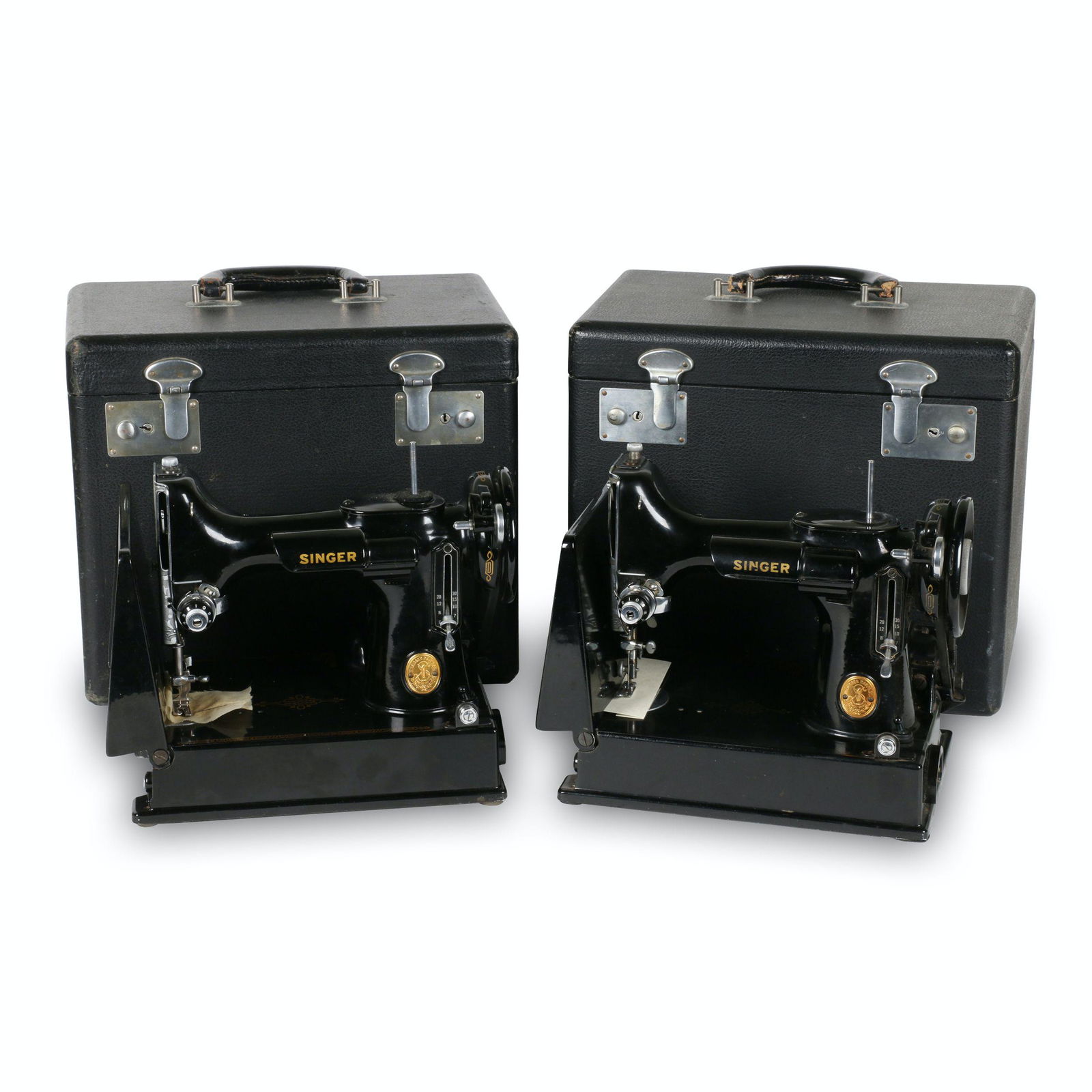 Two (2) Singer Featherweight Model 221s: American. 1940s. TWO (2) machines and two carrying cases (13.25” x 8.25” x 11.5”H) manufactured by the Singer Sewing Machine Manufacturing Co. between 1933 and 1968. The Model 221 is