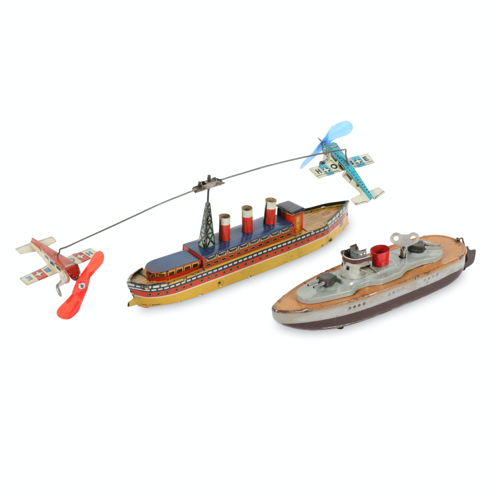 German Tin Litho Boat Toys: German. 1920s. Boat with airplanes marked, "Made in Germany". 9.5" to 10". Each functioning, gunner boat complete with key. Gun boat exhibits surface loss, mostly from bottom. $200/300