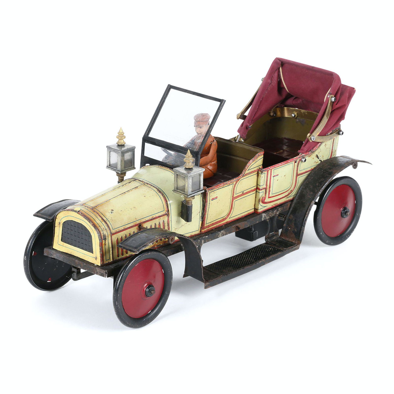 Carette Tin Litho Touring Car Toy: French. 1920s. Includes winding key. 12" x 4.5" x 6.5" (h). Functioning. Restored wheels and axels. Replaced folding top and cowl lamps. $600/800