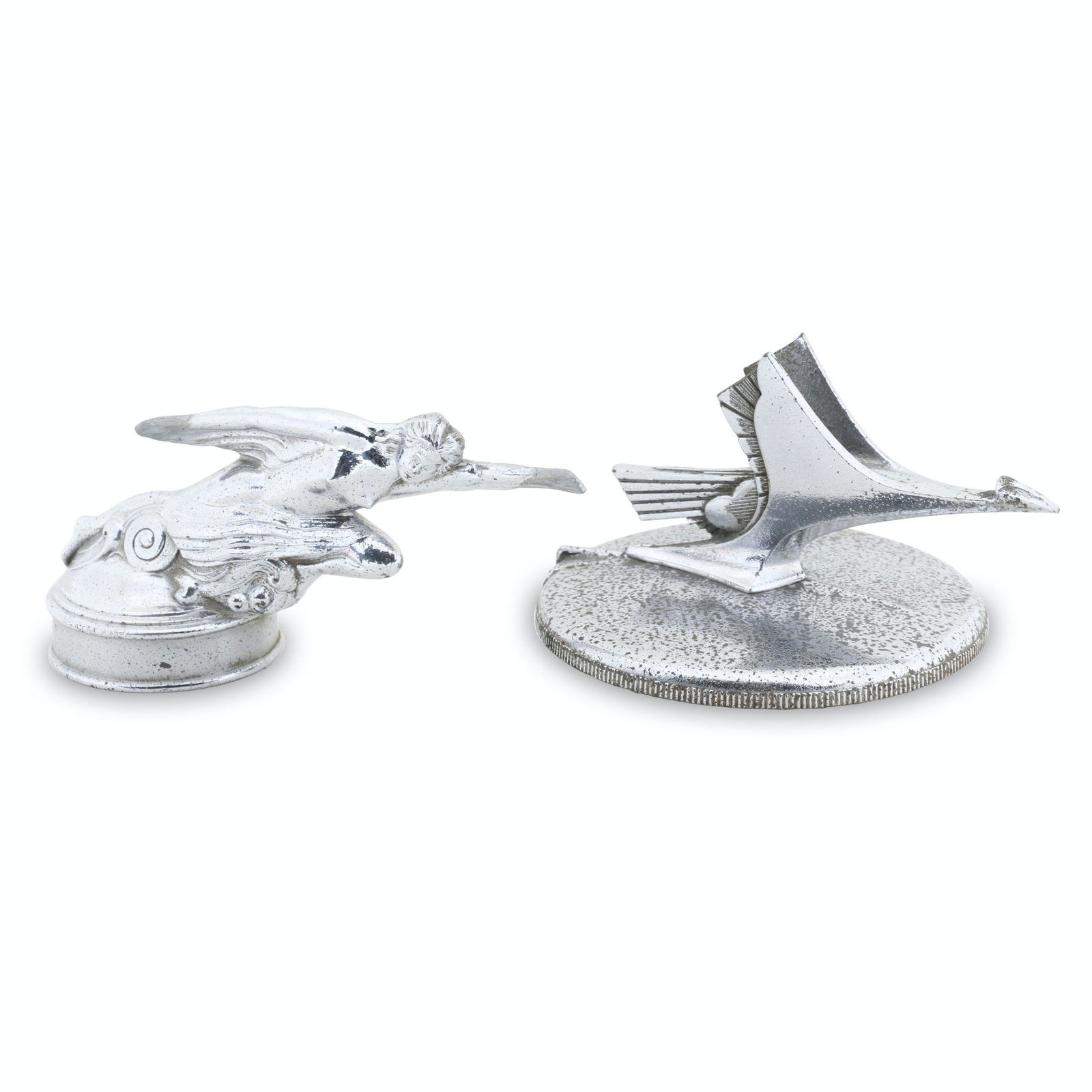 1927-29 and 1931 Studebaker Hood Ornaments: Two (2). American. 1927-29, 1931. One marked, "Stant Mfg Co, Connersville, Ind - Part # S-3200 Pat # 1806224 Stanco" underside. 6" to 7.5" (l). Lark example exhibits moderate pitting and missing wing