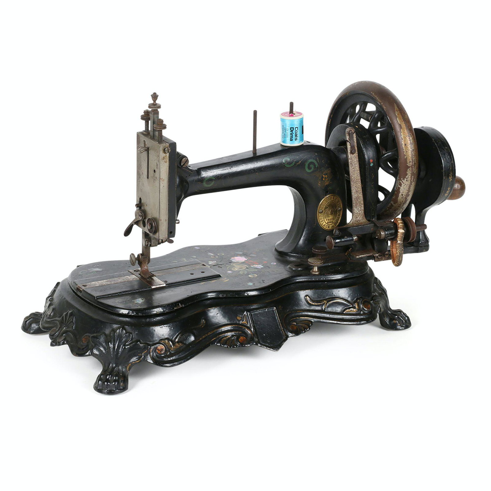 Gritzner Werke Sewing Machine: German. 19” x 8” x 10.5”H This hand crank lock stitch machine was made in Durlack Germany. The gold badge on the machine features a prominent spider in the centre of PATENT and TRADE