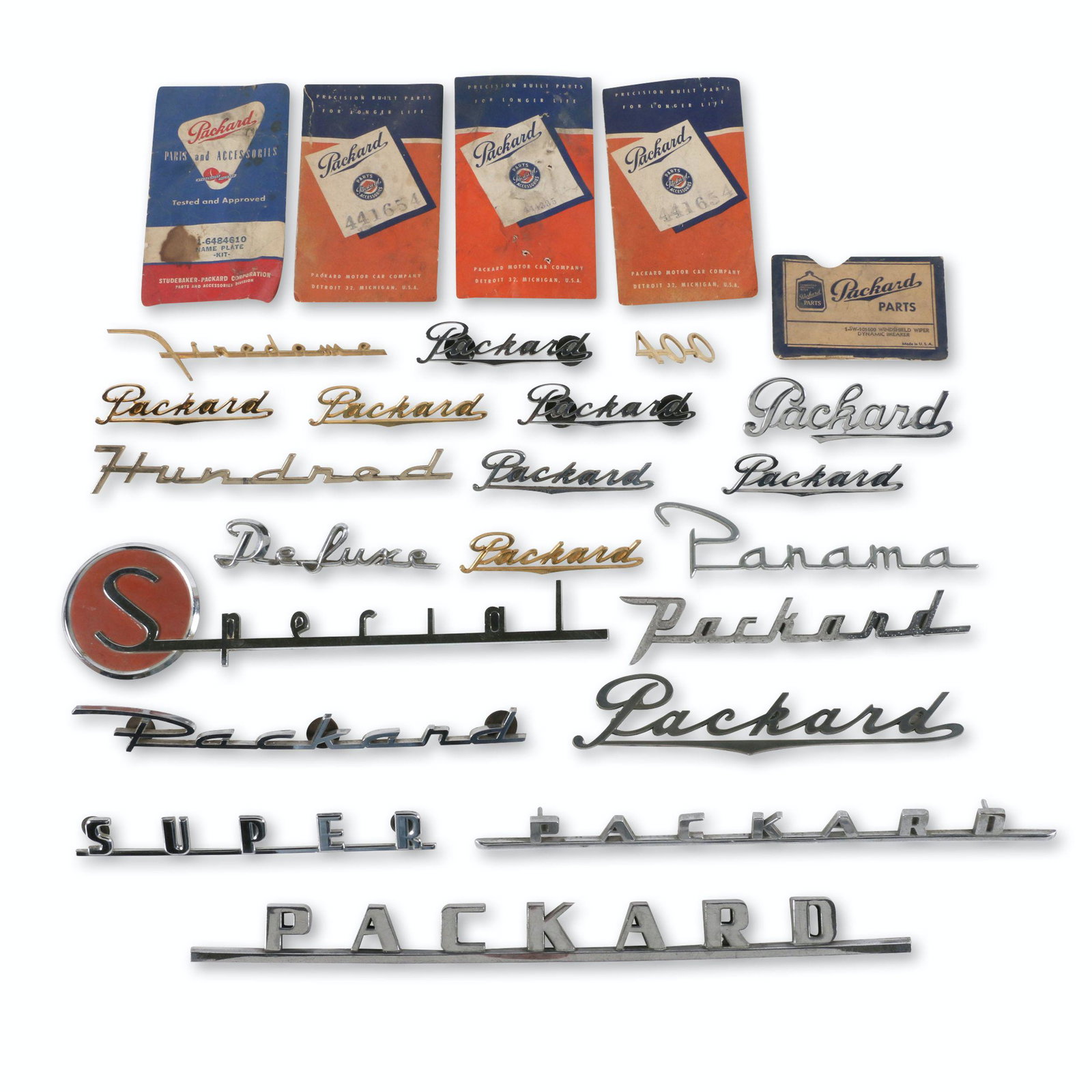 Assorted Packard Script Emblems: Twenty (20). American. 1940s-50s. Includes some original part sleeves. Many marked to rear with part numbers. 4" to 14.5" (l). Most appear new old stock or early take offs. $300/500