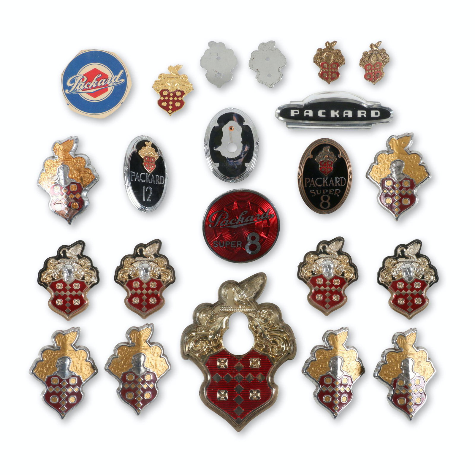 Assorted Packard Grille Badges, Emblems: Eighteen (18). American. 1940s-50s. Includes cloisonne, pressed steel and acrylic examples. 1" to 4.5". Includes large acrylic hood emblem. $300/500