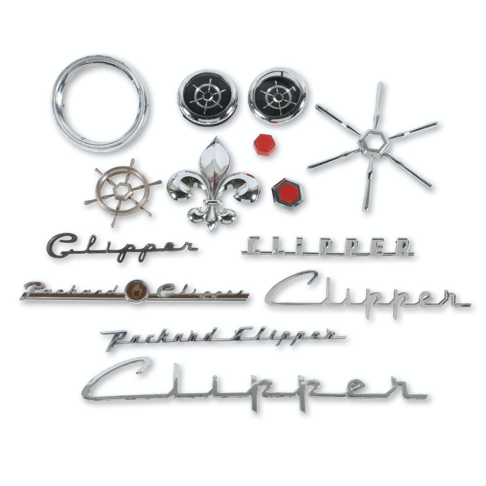 1950s Packard Clipper Emblems & Script: Twelve (12). American. 1950s. "Fleur de lis" emblem may be from a Marquette. 1.25" to 14". New old stock and early take offs. $400/600
