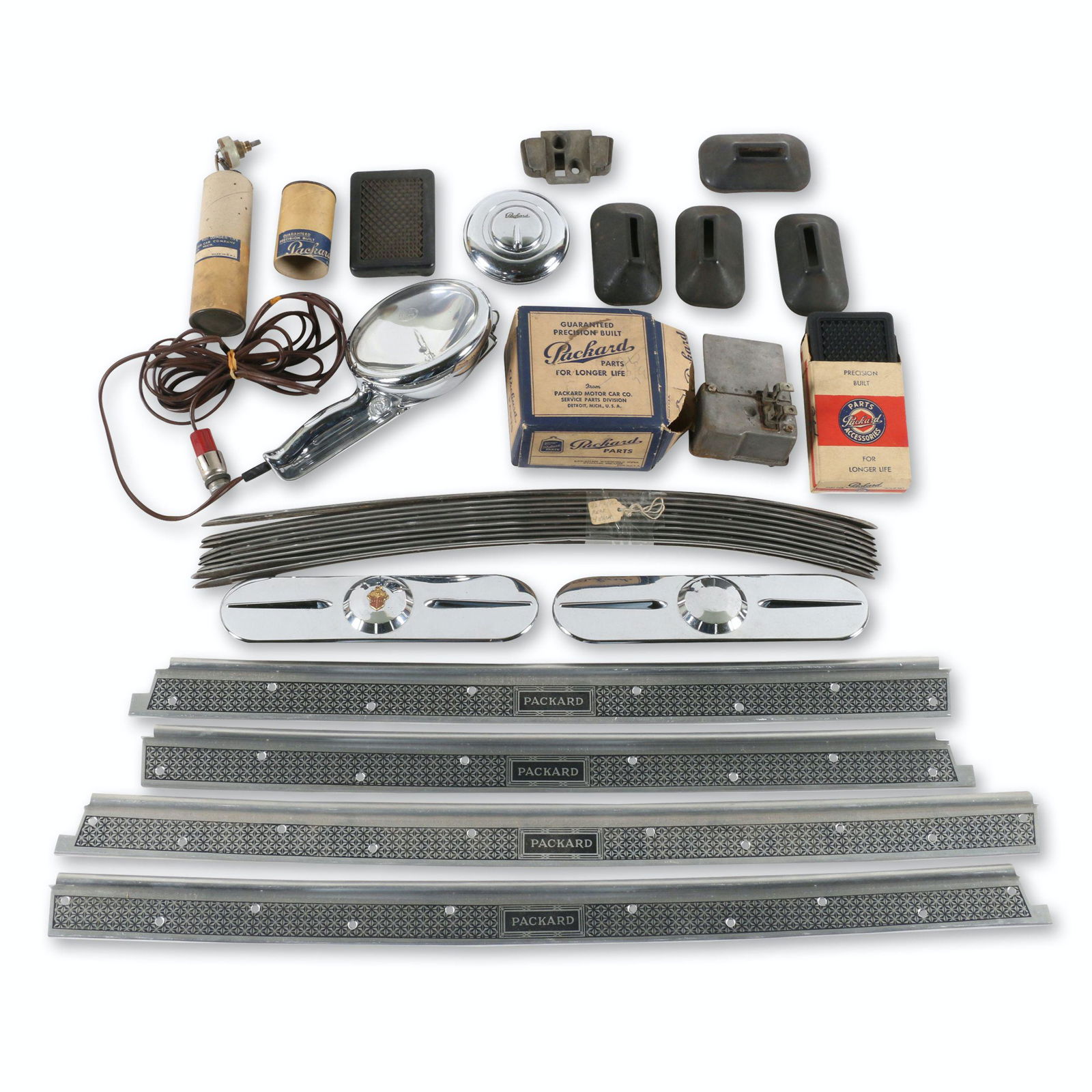 Assorted 1930s-40s Packard Parts & Accessories: American. 1930s-40s. Includes 1942 Packard rear fender trim, accessory locking gas cap, accessory utility lamp, gas pedal rubber, sill plates and radio delete plates. 3.5" to 27.5". $400/600