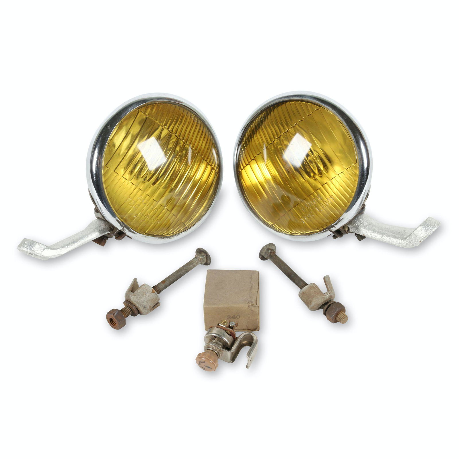 GM 1940s Guide Accessory Fog Lamps: American. 1940s. Includes new old stock fog lamp switch. Top of lamp marked, "Guide Fog Lamp 6-11/16 Made in USA". Lenses marked, "Guide Fog Lamp", lower edge. 6 11/16 lenses. Minor surface oxidation.