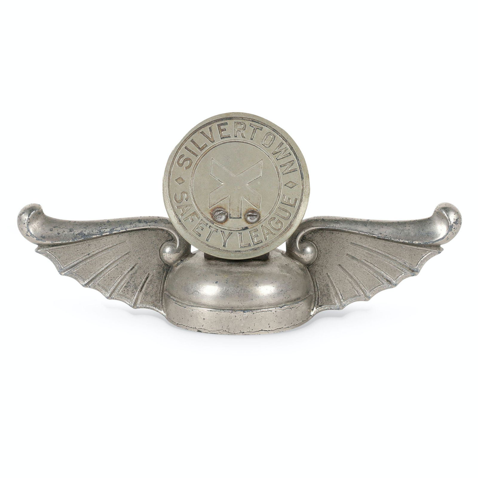 Goodrich Silvertown Tires Figural Rad Cap: Canadian. 1920s. Nickel plated base metal and stamped metal. Stamped, "Silvertown Safety League" 7 x 2.25 x 3.25". Surface exhibits uniform oxidation and scattered stress lines.