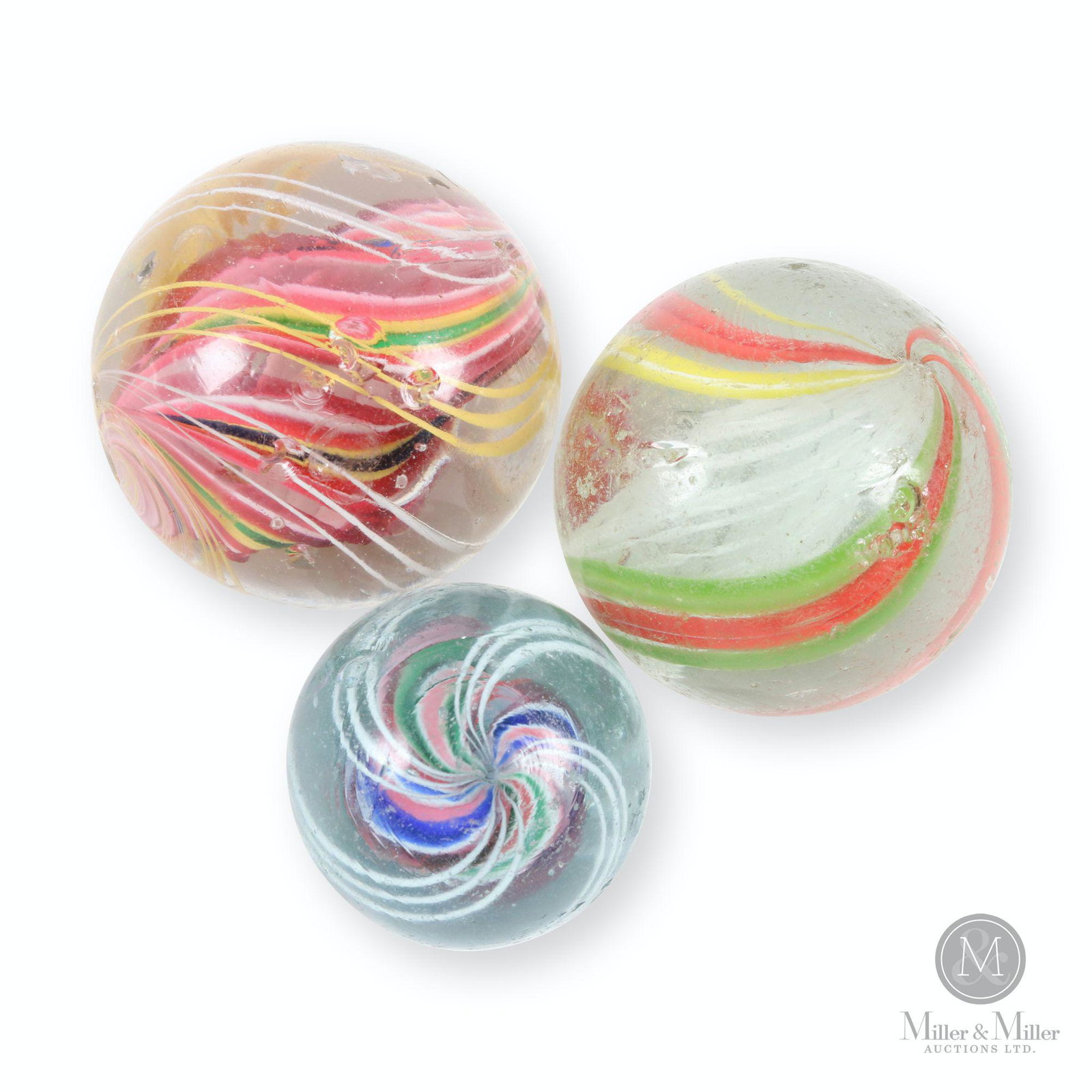 German Hand Blown Marbles: Three (3). German. 1890s. Hand-blown glass. 1.25 to 1.75" diameter. Each exhibits scattered minor to moderate surface flakes and fisheyes.