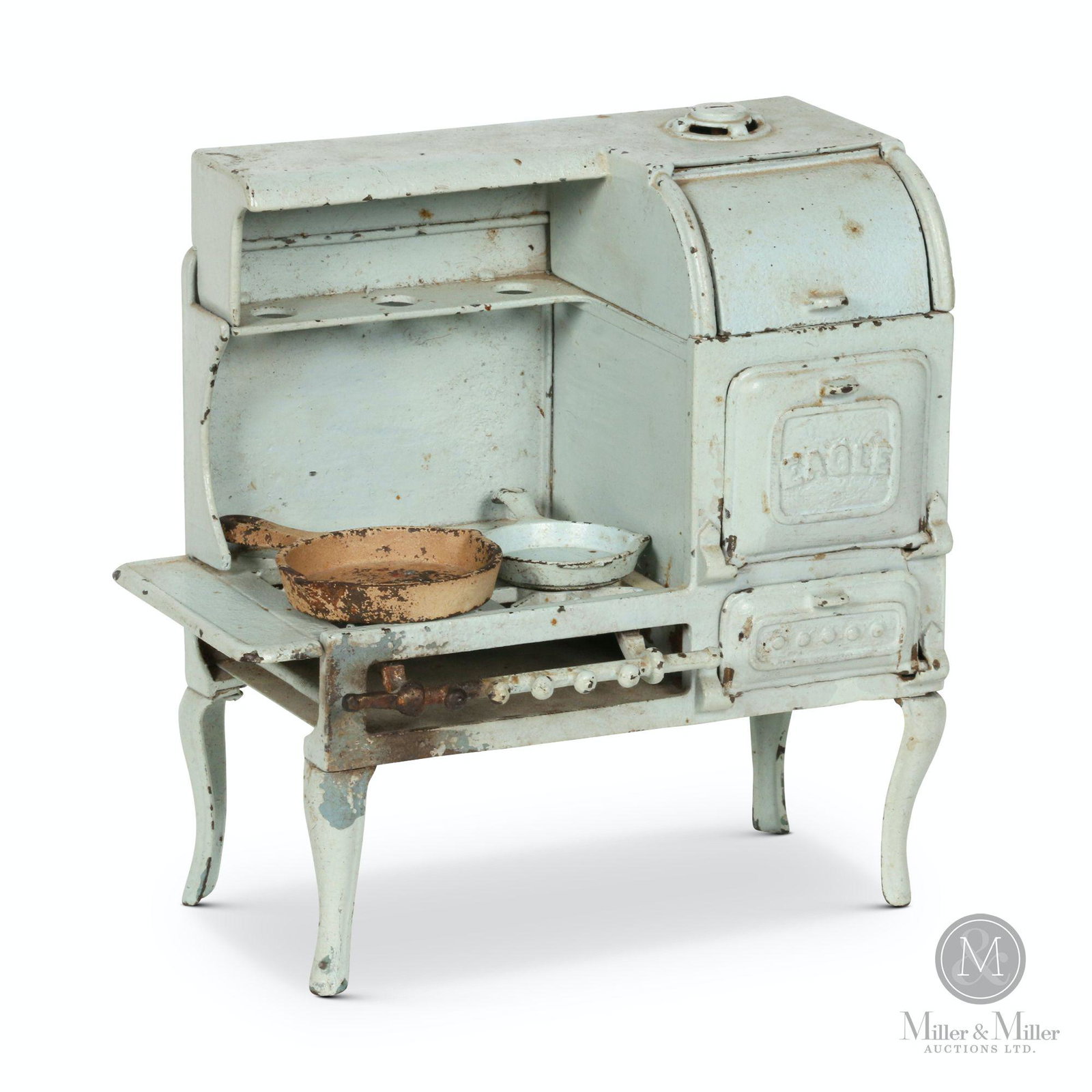 Cast Iron Eagle Child's Range: American. 1920s. Painted cast iron. Includes two miniature cast iron pans. Features cabriole legs and functioning doors. Stamped, "1429" underside. 10 x 5.5 x 10" (h). Jack Winkler collection.