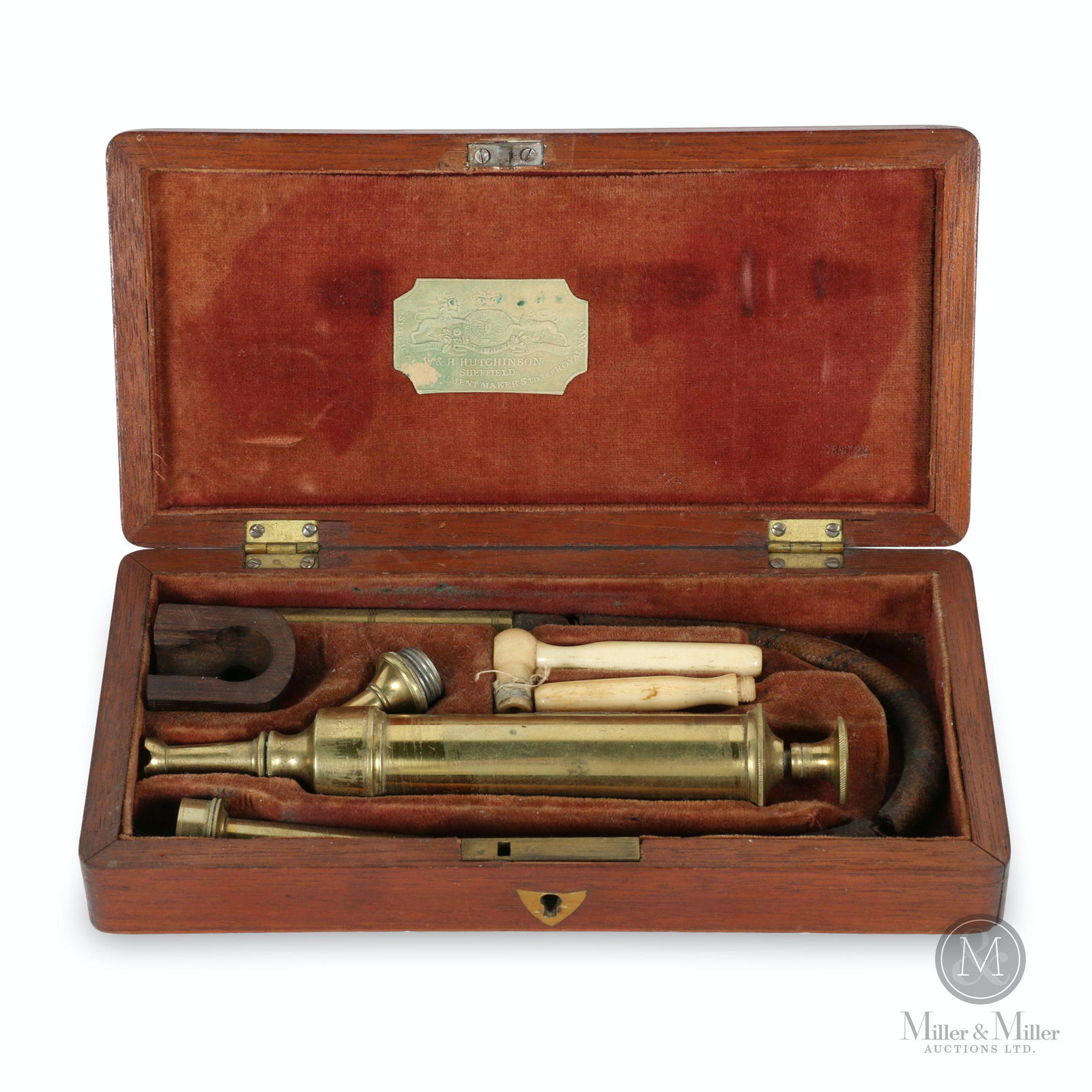 Early Medical Suction Device Wooden Case: English. 1890s. Tagged, "W & H. Hutchinson, Sheffield Surgical Instrument Makers to the Royal Navy" inner lid. 8.5 x 4.25 x 1.75" (h). Original hose is dried, split in three pieces.