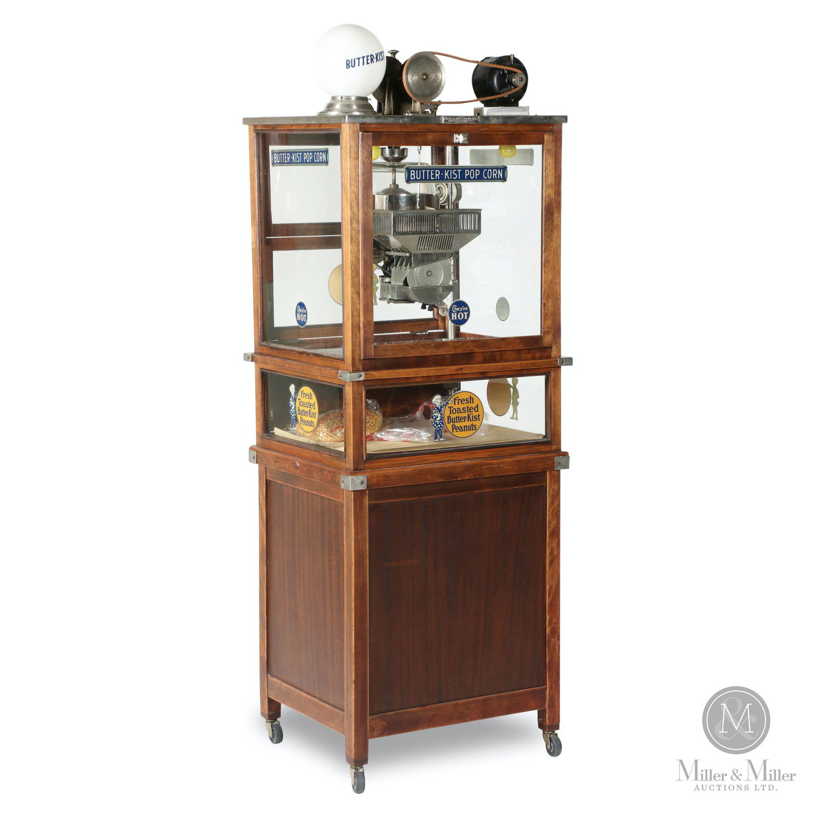 Holcomb & Hoke Butter-Kist Popcorn Machine: American. 1910s. Walnut case. Floor model variation with an assortment of related ephemera including branded popcorn bags, operating instructions and sales literature. Tagged, "Made by "Holcomb and Ho