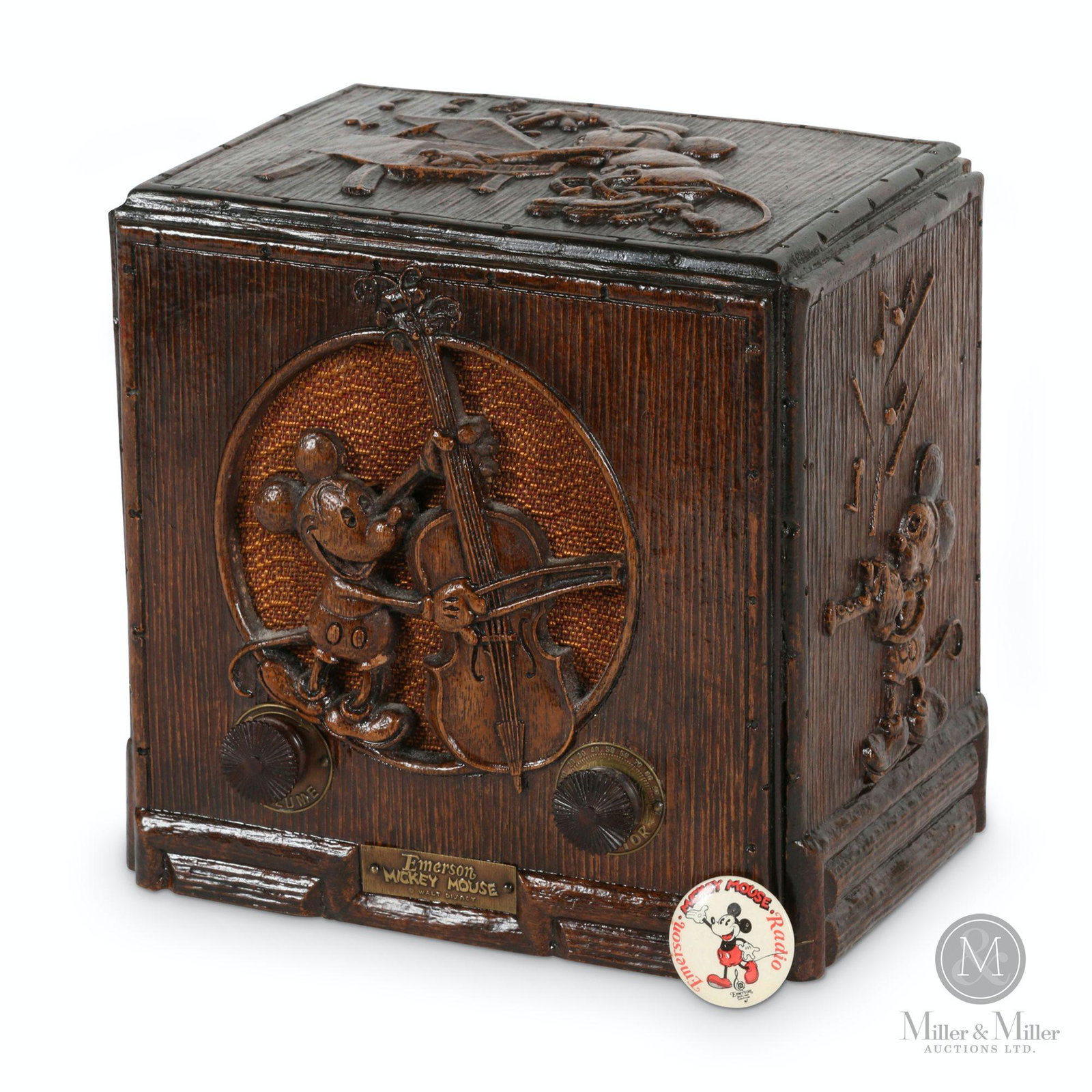 Emerson Model 411 Mickey Mouse Radio: American. 1930s. Pressed composite simulated carved oak case. Includes Emerson Mickey Mouse Radio promotional celluloid pinback. Marked, "Emerson Mickey Mouse Walt Disney" front, "Emerson Radio & Phon
