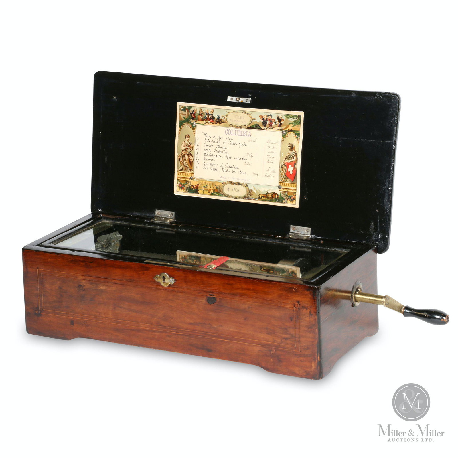 Swiss Columbia 8-Tune Cylinder Music Box: Swiss. 1890s. Inlaid rosewood case. Crank wind. Stamped, "M-F 1816 Patented Sept 22, 1885 - Dec 6 1887 - Mai 8 1888 - D.R.P. 33516 43585". 18 x 8.25 x 5.5" (h). Mechanically functioning. Play/Stop swi