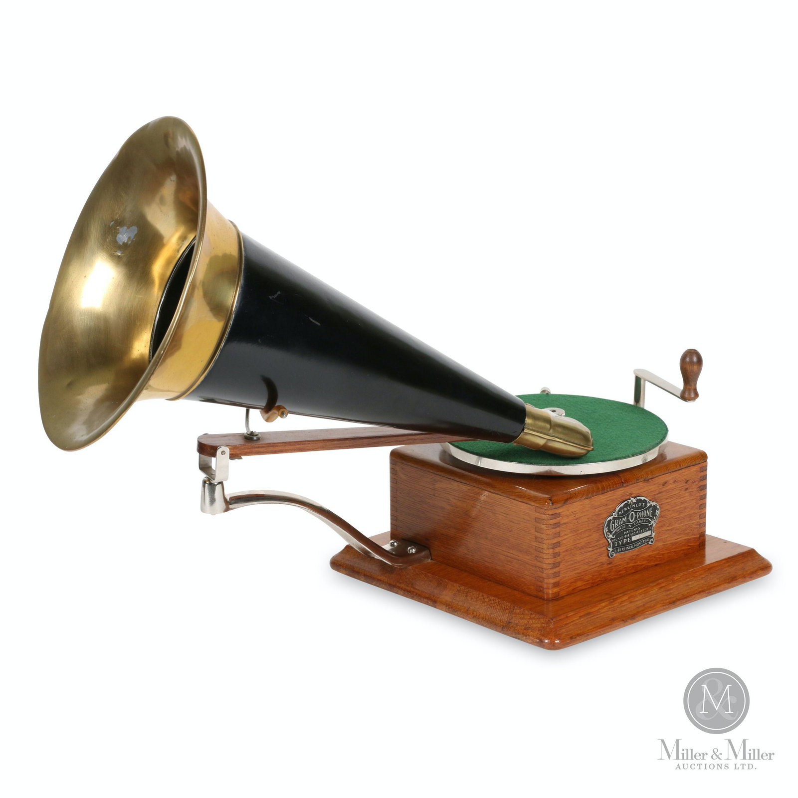 Berliner Model A Trademark Gramophone: Canadian. Circa 1903. Quarter-sawn oak case. Crown badge stamped, "Berliner GRAM-O-PHONE Co. of Canada Ltd. Type A6077 Montreal Pats. 55078 & 55079 Feb 24, 97". Cabinet 10 x 10 x 4.5" (h). Horn 10 x 1