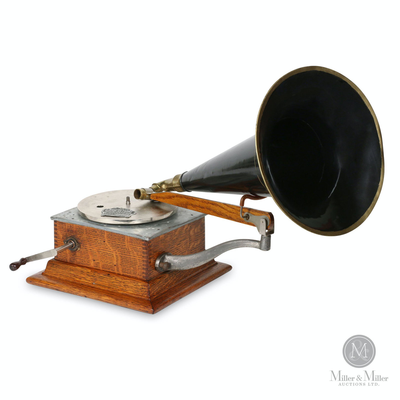 Berliner Model E "Bijou" Gramophone: Canadian. 1900s. Quarter-sawn oak case. Includes original stamped crown badge, unattached. Includes crown badge stamped, "Berliner's Gram-O-Phone Made in Canada Patents Nos. 55078 & 55079 Feb 24, 97 T