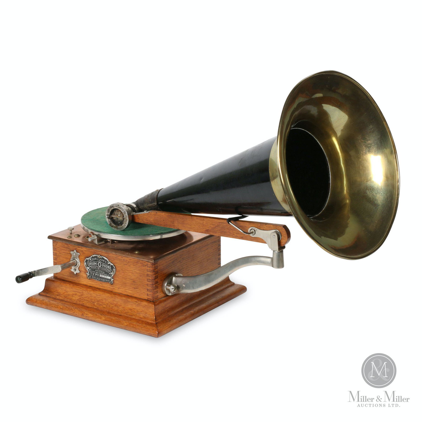 Berliner Model E Gramophone: Canadian. 1900s. Quarter-sawn oak case. Crown badge stamped, "Berliner GRAM-O-PHONE Co. of Canada Ltd. Type E 105 Montreal Pats. 55078 & 55079 Feb 24, 97". Reproducer stamped, "E. Berliner's Pat'd 189