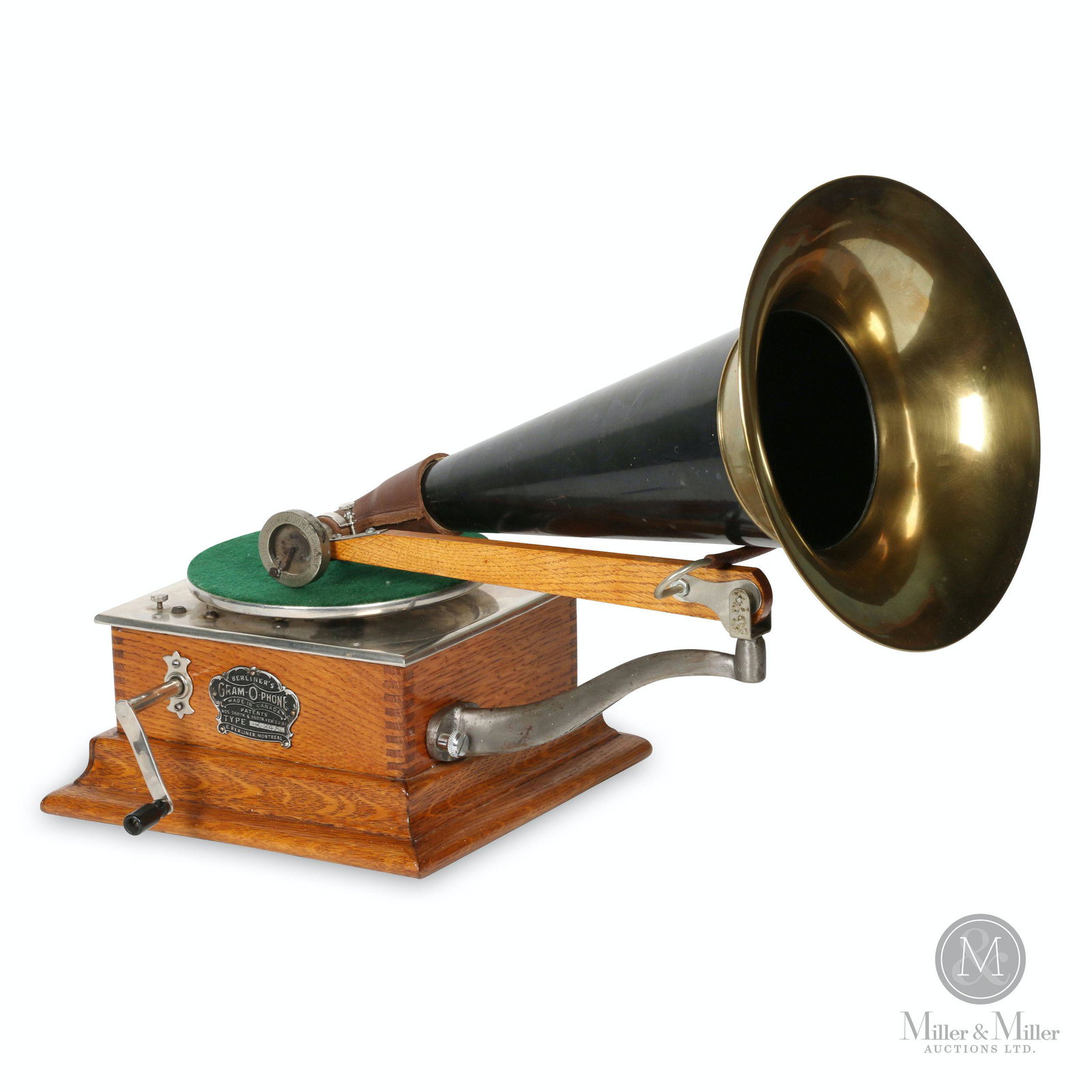 Berliner Model E Gramophone: Canadian. 1900s. Quarter-sawn oak case. Crown badge stamped, "Berliner GRAM-O-PHONE Co. of Canada Ltd. Type E345 Montreal Pats. 55078 & 55079 Feb 24, 97". Reproducer stamped, "Automatic BERLINER Sound