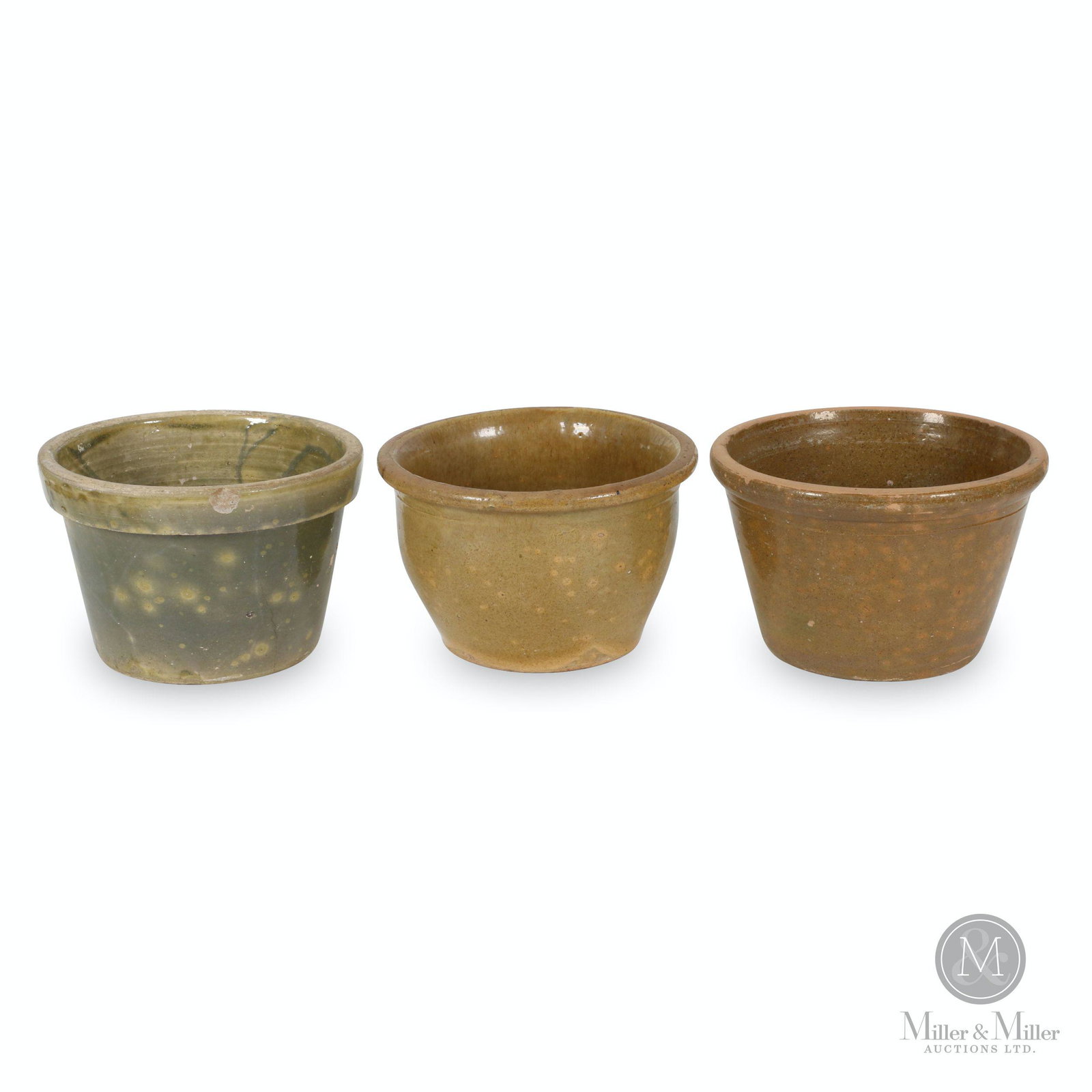 Earthenware Shilling Crocks: Three (3). Canadian. 1870s. 10" to 10.25" (d). One exhibits added hole through base and hairline crack. Minor interior glaze loss. Brian Stead collection.