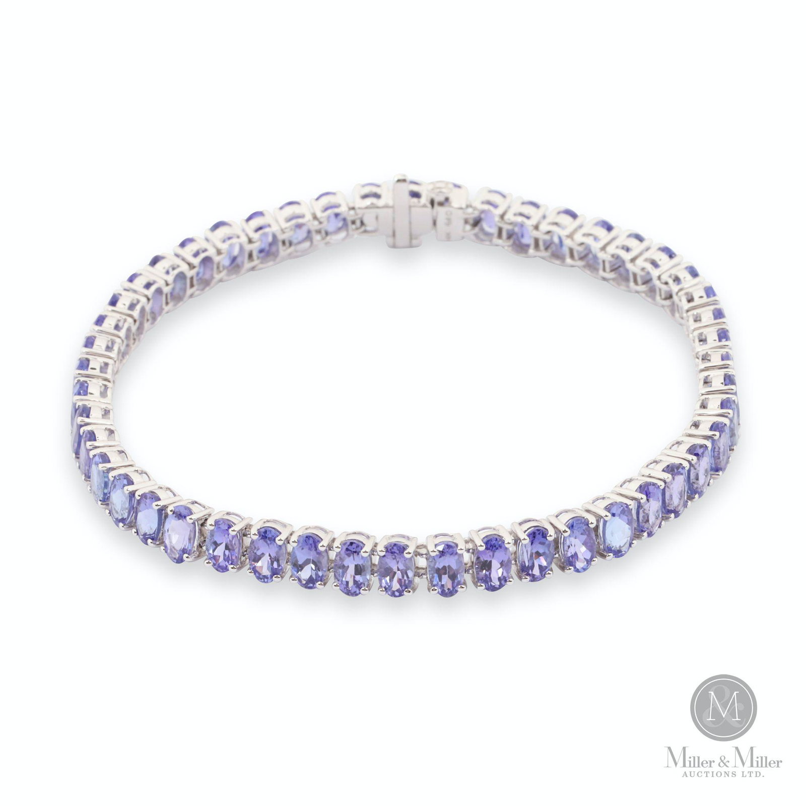 14K White Gold Tanzanite Bracelet: Accompanied by certificate of appraisal. One lady's Tanzanite tennis bracelet in 14K white gold with 48 0.20ct tanzanites. CODE-JEWE