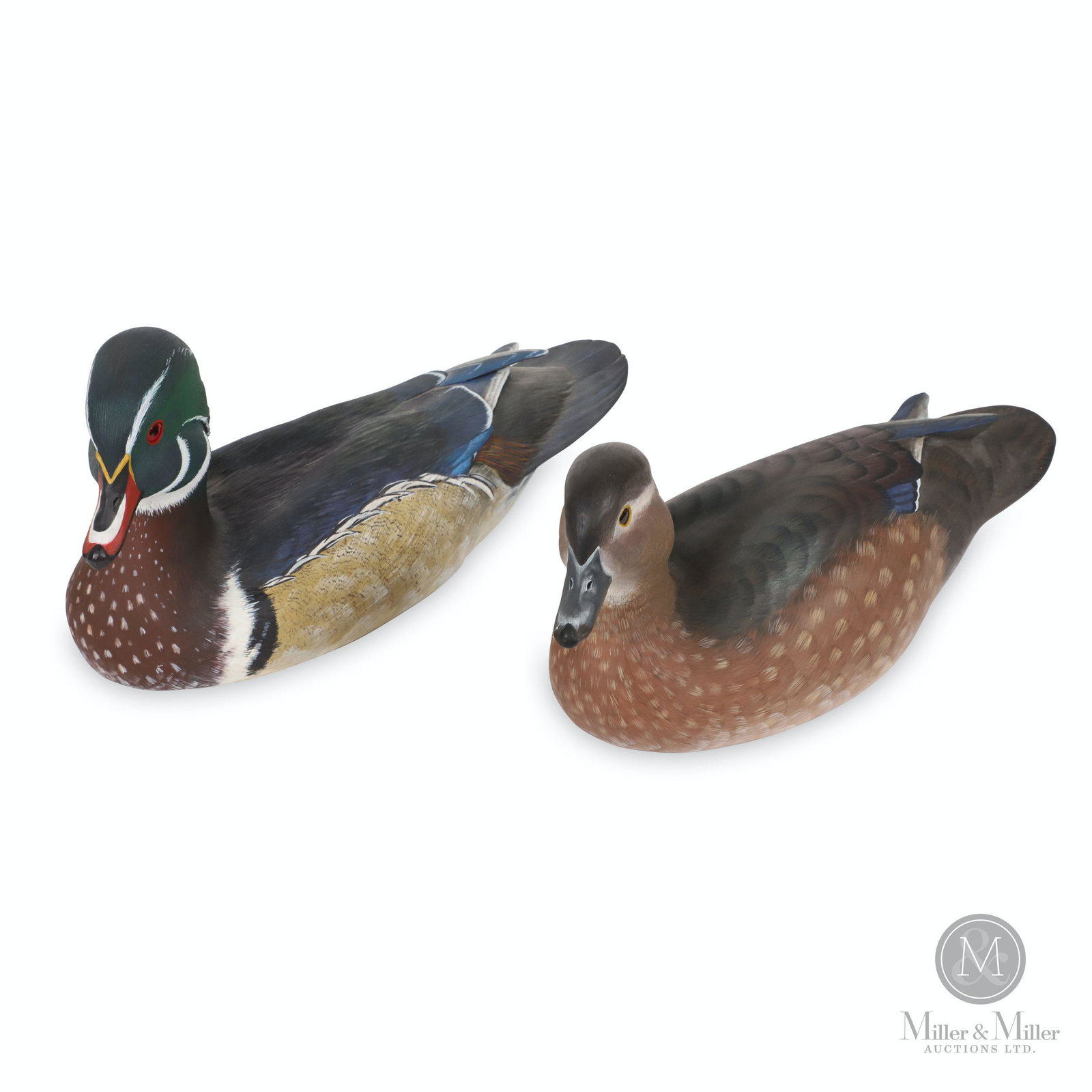 Ian Crokam, Wood Duck Drake & Hen: Two (2). Canadian. 1987. Painted carved basswood. Each marked, "The Call of the Loon Decoys Ltd., Shanty Bay, Ontario, Ian & Joanne Crokam". 12.5 to 13.5" (l). CODE-DCOY