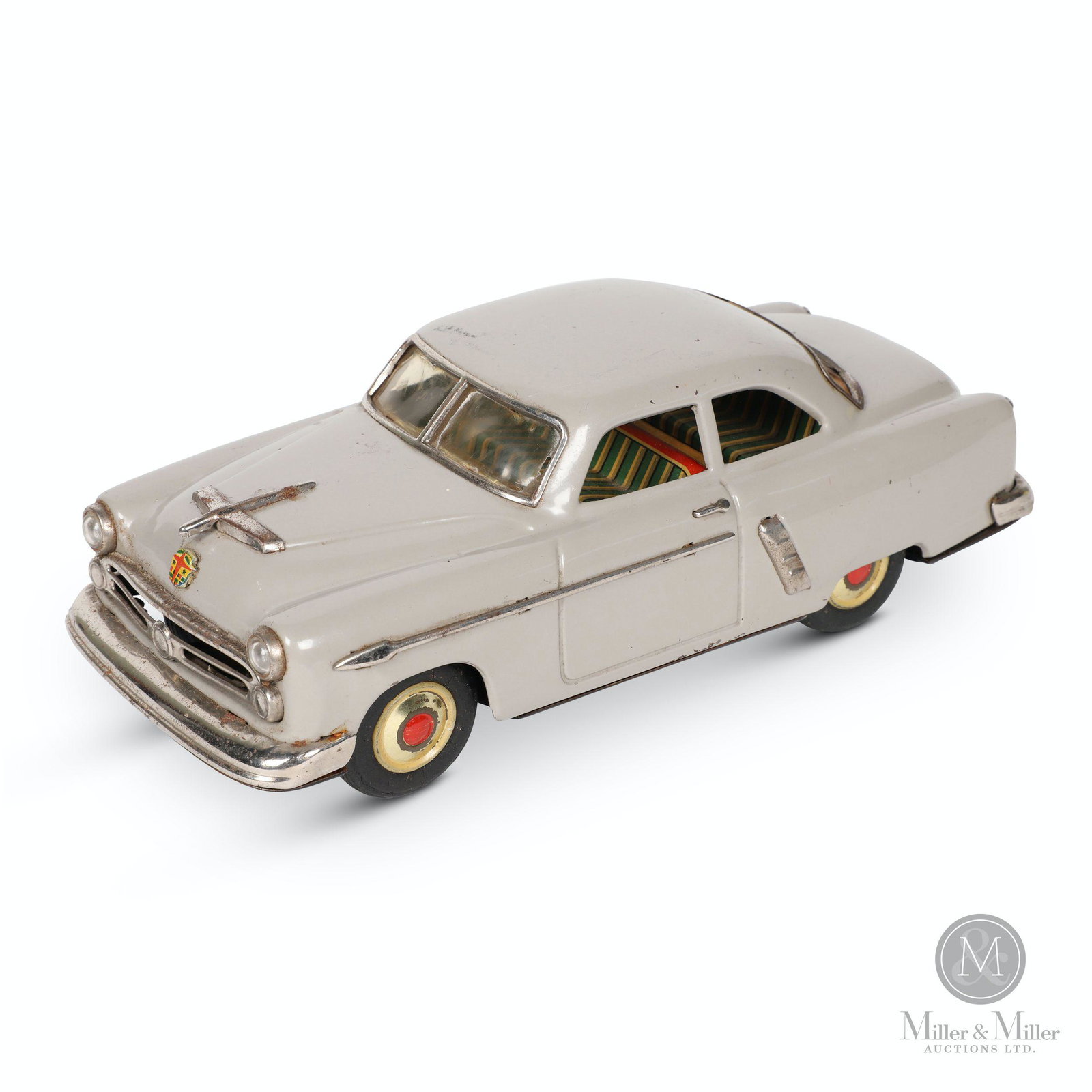 Marusan 1952 Ford Tin Litho Toy Car: Japanese. 1950s. Lithographed tin. Features rear-wheel drive friction action. Marked, "Marusan Toys Japan - Kosuge", underside. 10.5 x 4.25 x 3.5". Minor shallow impression to roof. Minor oxidation to