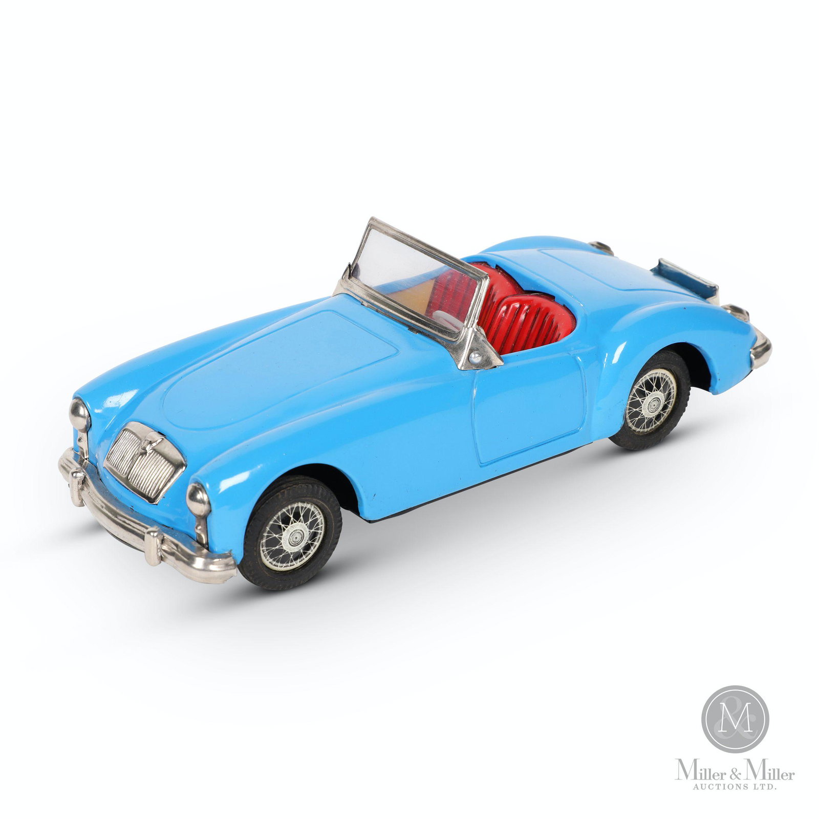 Japanese Modern Toys MG Roadster Toy: Japanese. Circa 1960. Friction. Lithographed tin. Blue. Marked, "MG - 3061" on license plate and "MT" trademark on dashboard. Scratch to passenger's side door and fender near rocker panel. 9 x 3.5 x 2