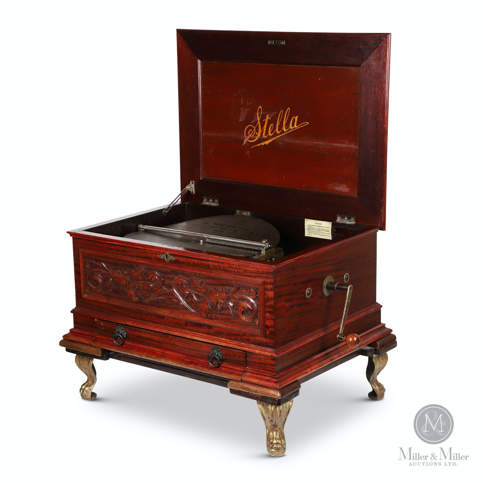 Large Stella Music Box with 24 Discs: Swiss. 1897. Carved mahogany. Made by Mermod Freres. Includes twenty-four 17" disks including God Save the King and Silent Night. Also includes removable stand. Marked "Stella" underneath lid. 14.5 x 