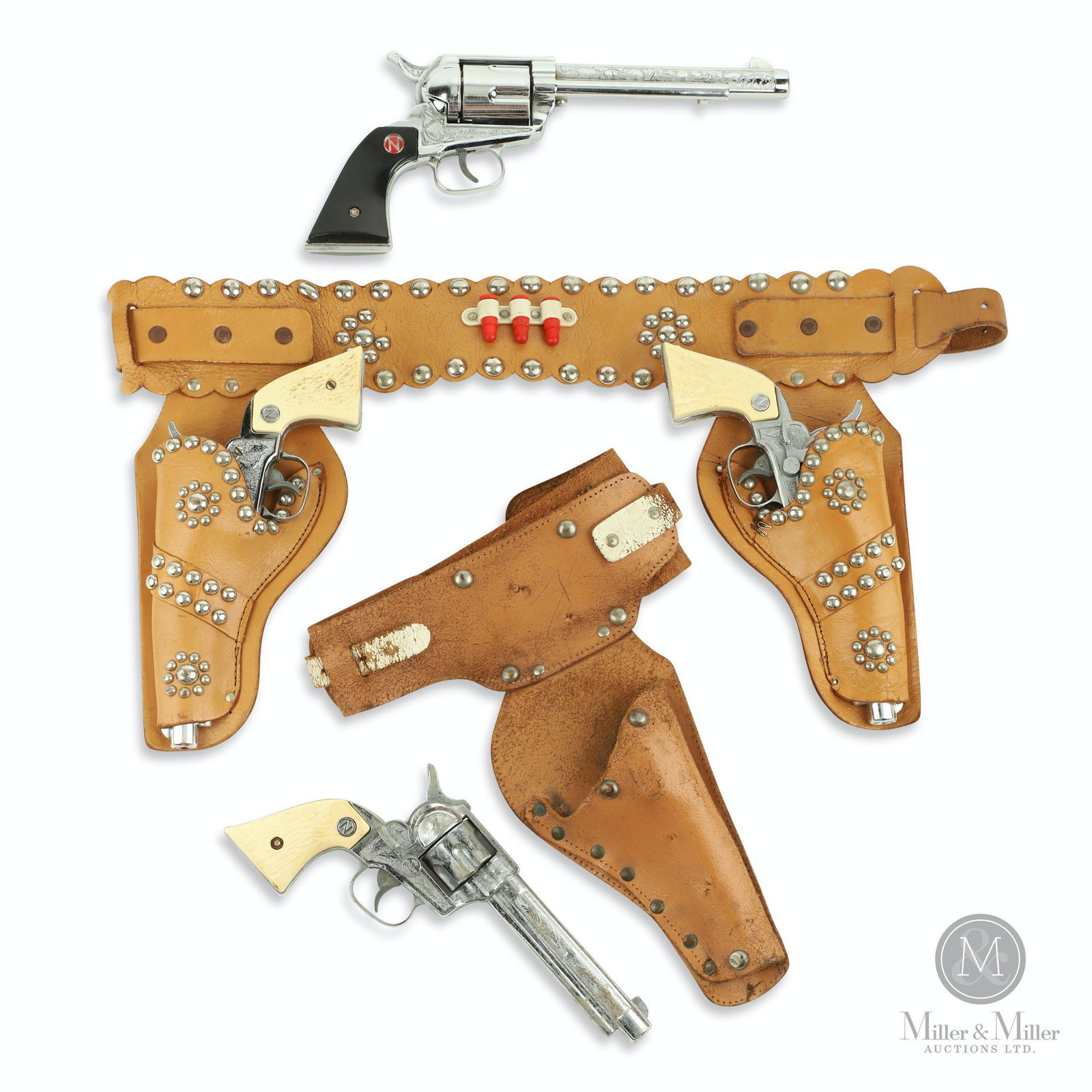 Nichols, Stallion 38 & 45 Cap Gun & Holster Sets: Three (3). American. 1950s-60s. Diecast metal guns with plastic components. Includes: Nichols Stallion Double Holster Gun set (1955), Nichols Stallion 38 in Holster (1952), and Nichols Stallion 45 Sil