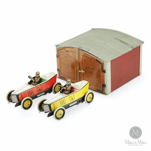 Greppert & Kelch, 2 Bay Garage & Wind-up Cars: German. 1920s. Lithographed tin. Marked, "Gundka G &K Made in Germany" on cars. 4 1/2 x 6 3/4 x 8". Cars are mechanically functioning. Red car exhibits minor fade. Garage and cars exhibit very minor