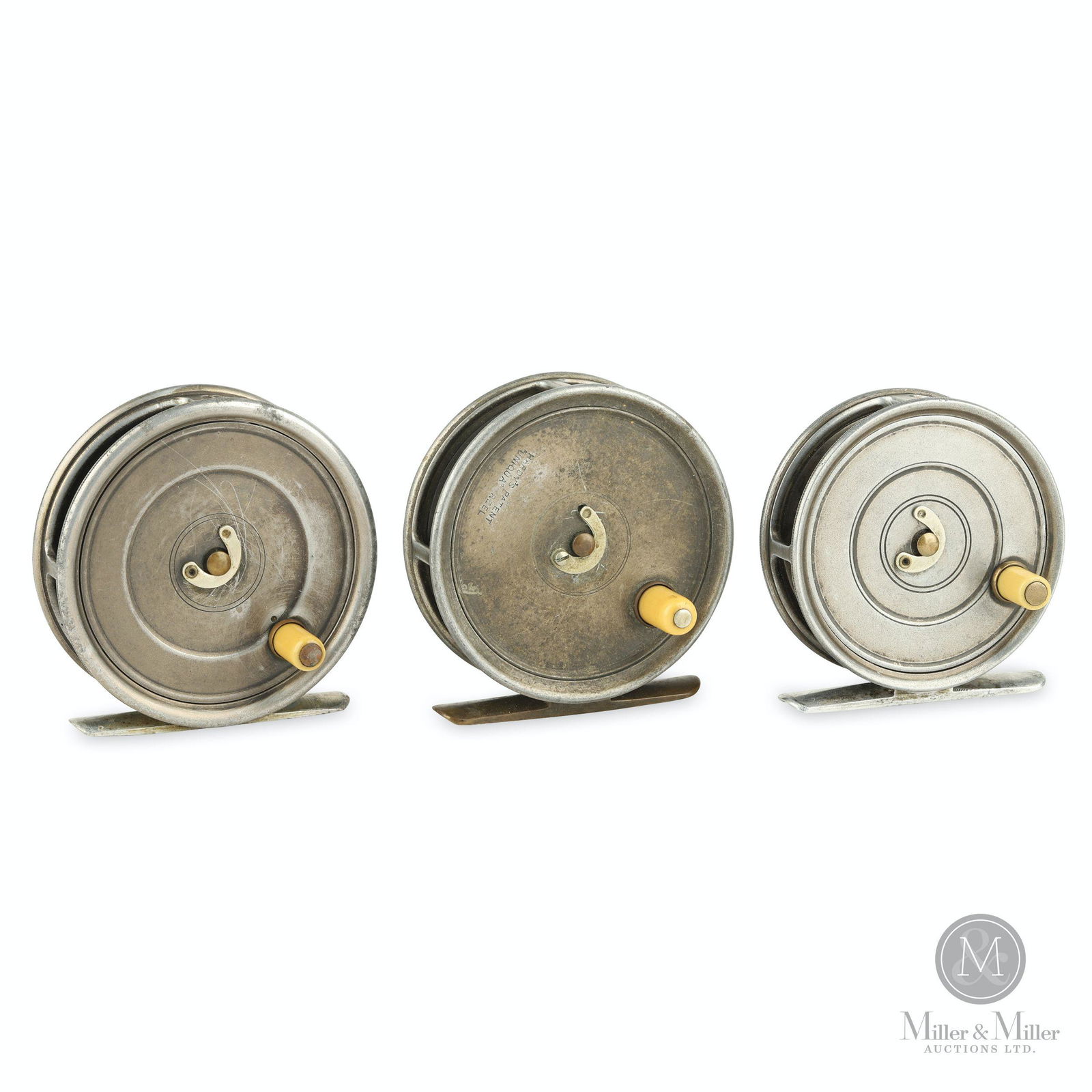 Three Hardy Bros. Uniqua Fly Reels: Three (3). English. Circa 1903-1921. Narrow drum. Two feature alloy foot, one features smooth brass foot. Each feature horseshoe latch. Each stamped, "Hardy's Patent Uniqua Reel". Two 3 1/8" diameter