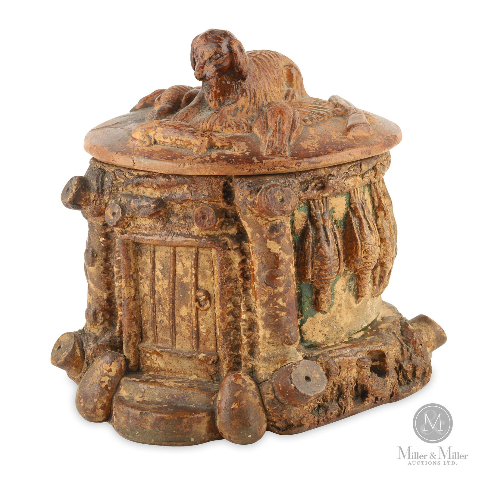 Earthenware "Hunting" Humidor/Pot: An earthenware covered humidor/pot with hunting motifs. The pot has a "cabin in the woods" theme with game hanging on the outside log walls while the lid shows an attentive dog alongside a shotgun, ra