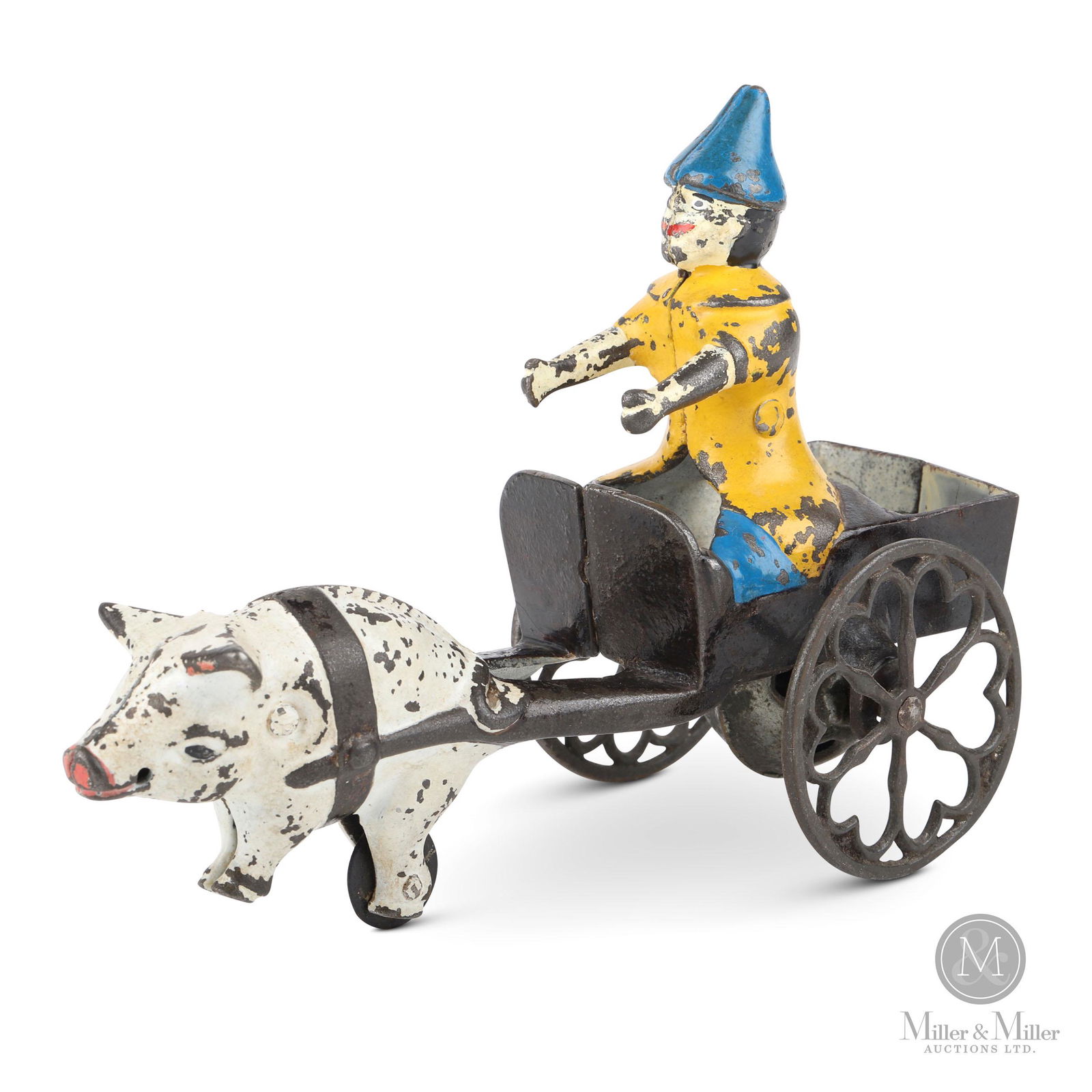 Cast Iron Clown on Cart: Pull toy with bell. From the Tanenbaum Collection. Painted cast iron. The toy exhibits scattered areas of moderate paint loss. Heavier paint losses are evident on the clown's back and arms. Original r