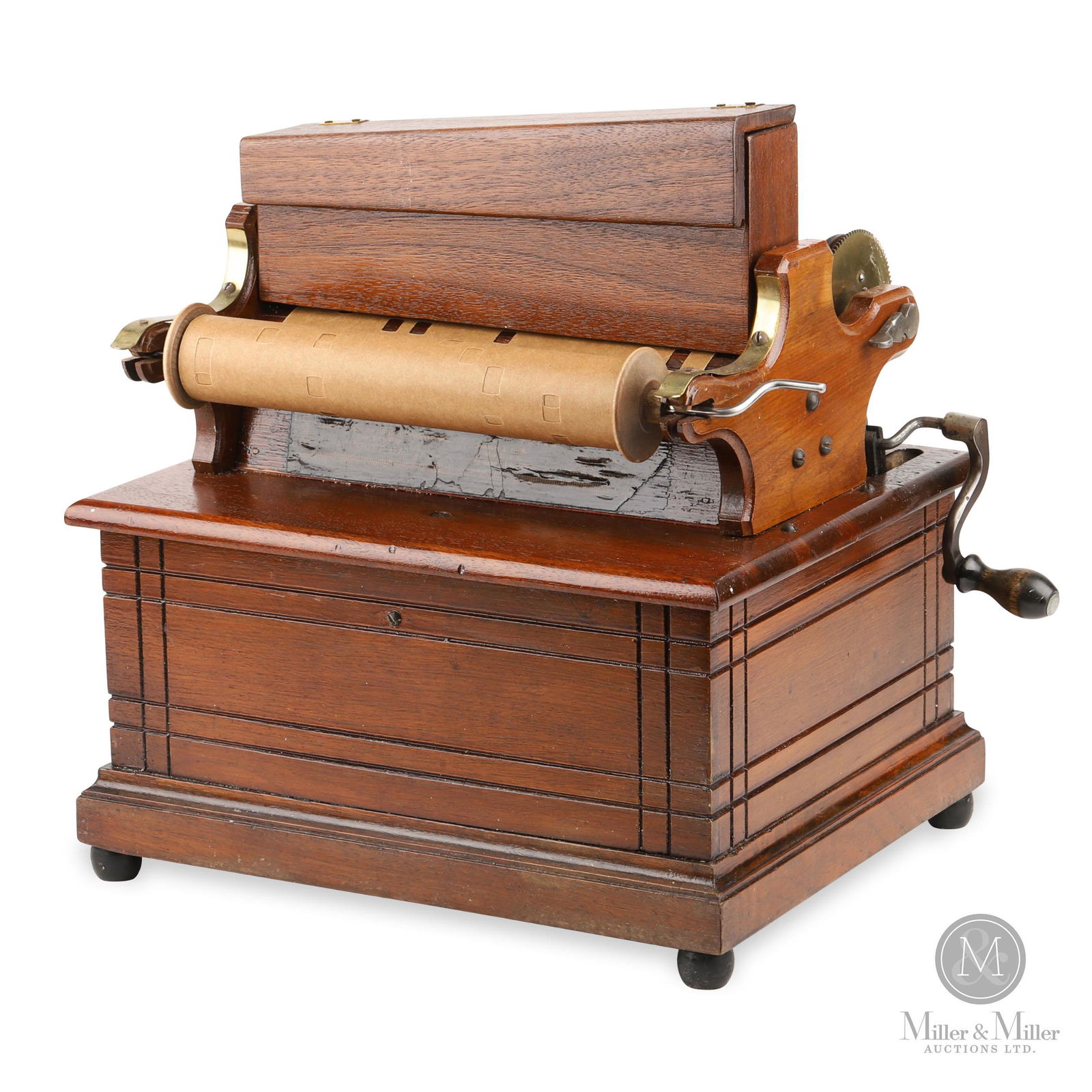 Reed Pipe Clariona Paper Roll Organette: A paper roll organette by Merritt Gally, New York, with attractive carving on the case. An example of the various styles of hand-cranked reed organs popular in the late 1800s before the phonograph rea