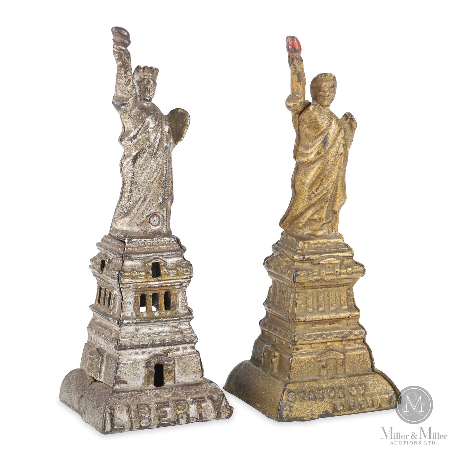 A.C. Williams and Kenton Hardware Statue of Liberty Still Banks: Two Statue of Liberty Still Banks. From the Tanenbaum Collection. Painted cast iron. The example with the silver finish is missing the trap. Both examples exhibit some soiling and moderate surface los