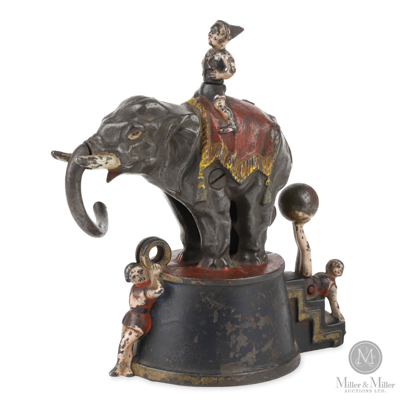 J. & E. Stevens, 3 Clown Circus Elephant Mechanical Bank: Place a coin between the rings held by the acrobat. Move the ball on the feet of the other acrobat and the elephant will strike the coin with his trunk, causing it to fall into the receptacle below. A