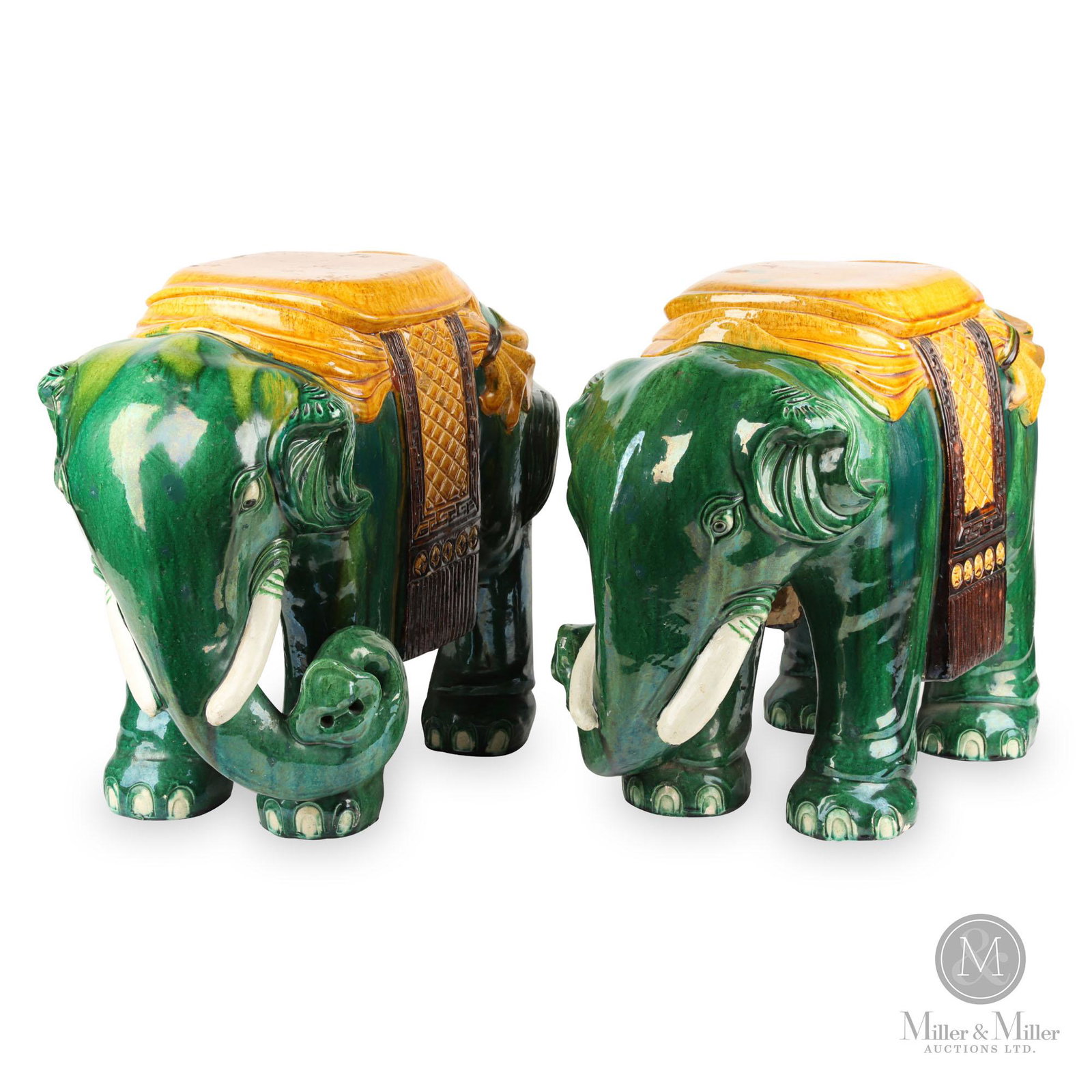 Pair of Chinese Elephants: Pair of Chinese pottery elephant form garden seats. The green glazed elephants each supporting a yellow seat. From the Robert Bolus Estate. Overpainted with green accents. Some glaze chips with touch 