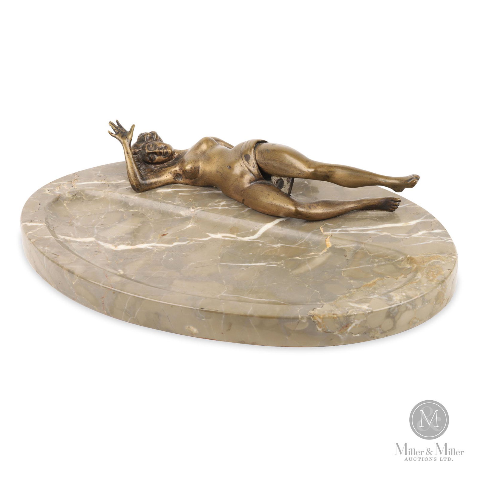 Combination Vide Poche Cigar Cutter: An early 20th century combination vide-poche and gilt patinated figural cigar cutter. The reclining and gilt patinated figure of a young woman fitted with an articulated leg that operates a guillotine