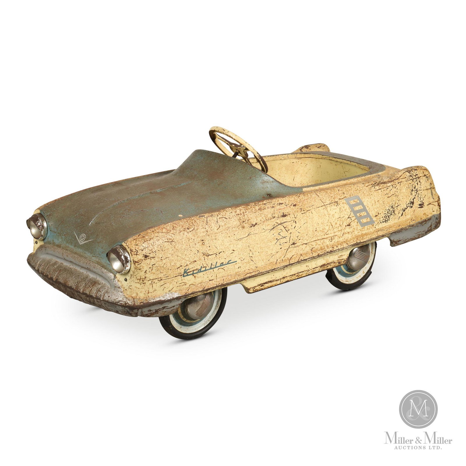 Gendron Kidillac Pedal Car: American. 1950s. Pressed steel. Exhibits moderate to heavy surface scratches, losses and accompanying oxidation. Missing spare tire. From the Joe Byway Collection. 18.5 x 46 x 18".