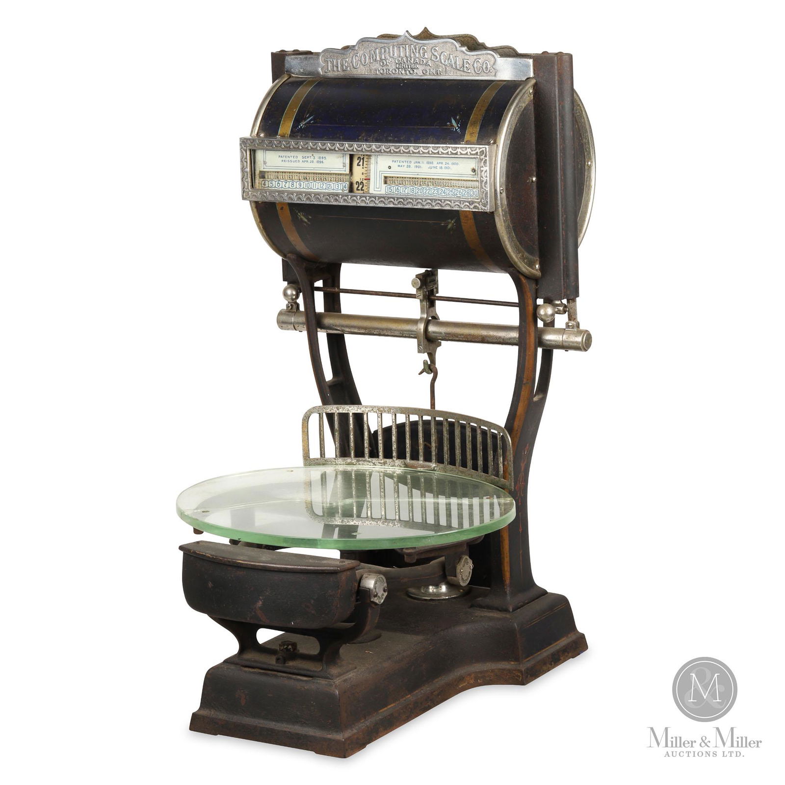 Computing Scale Co. General Store Drum Scale: Canadian. 1910s. Painted steel with nickel plated trim. Plate glass platform exhibits a repaired crack through the center. Nickel plating and painted surfaces exhibit minor oxidation. Top sign marked,