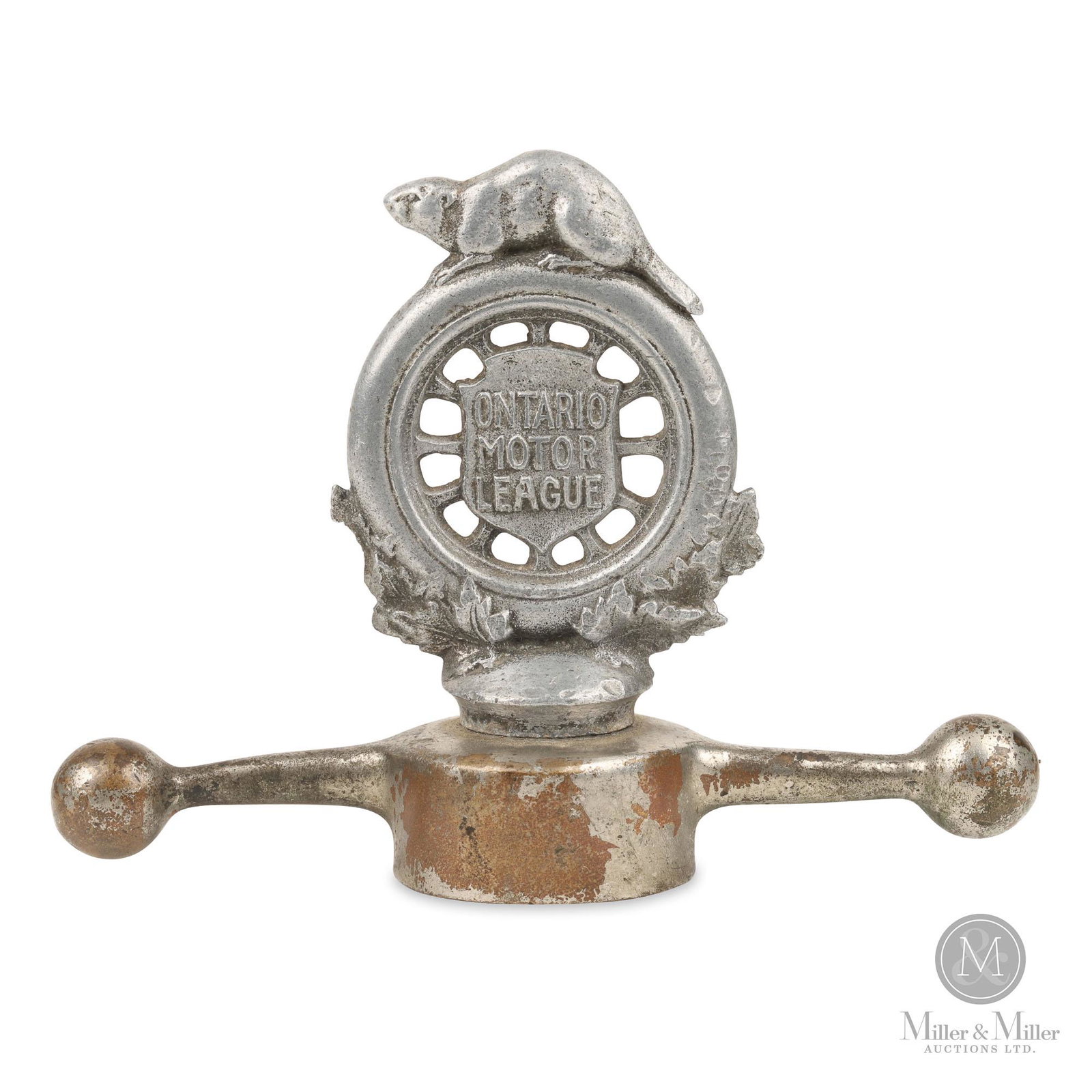 Ontario Motor League Hood Ornament: Canadian. c1915. Nickel plated base metal. Nickel plated "dog bone" exhibits moderate plating loss. Figural radiator cap features the iconic Ontario Motor League "beaver on tire" logo. Horseless Carri