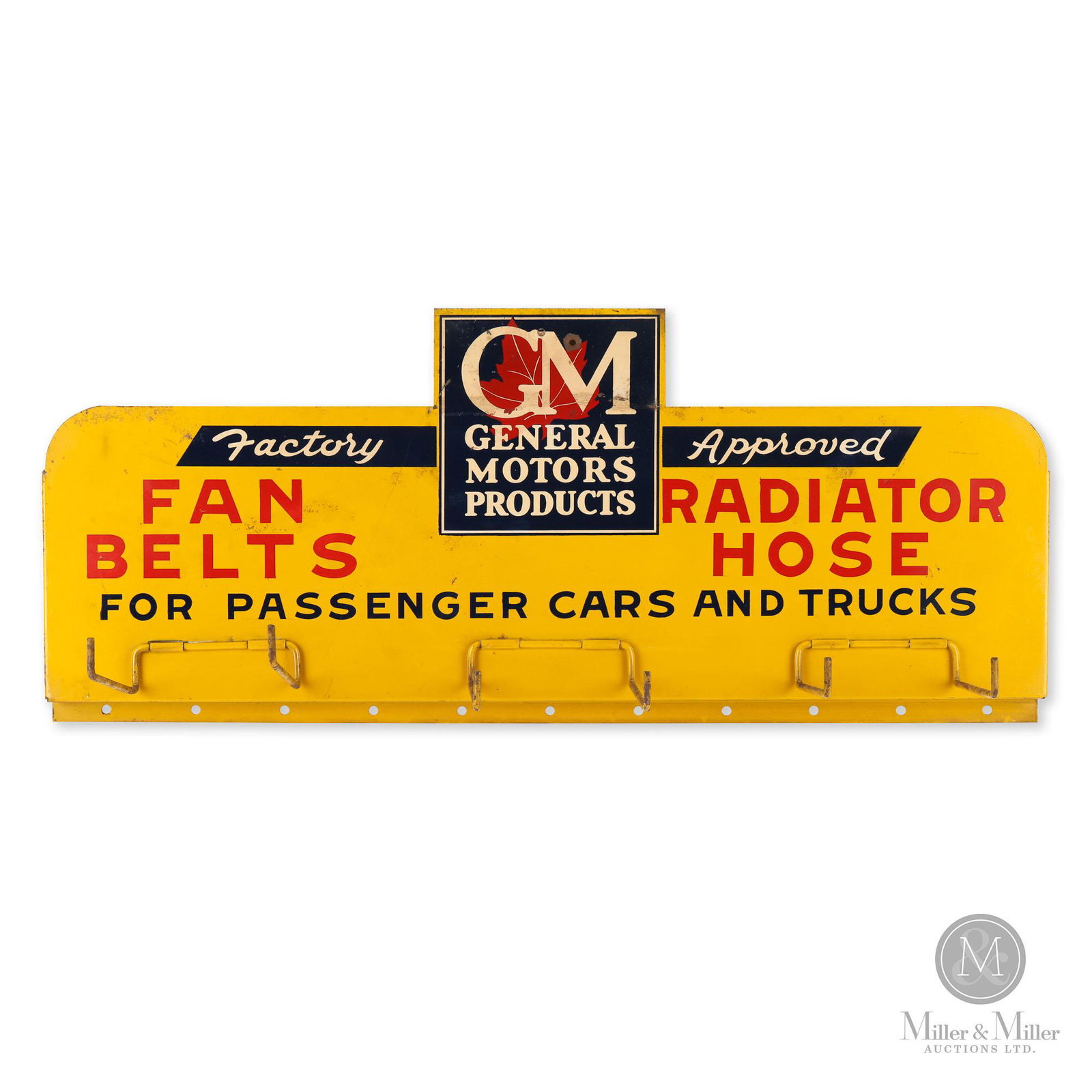 GM Fan Belts and Radiator Hoses Rack Sign: Canadian. 1940s. Single sided tin (SST). One added mounting hole with resulting surface losses surrounding through the GM logo. Features the Canadian General Motors maple leaf logo. 11" x 25" x 2".