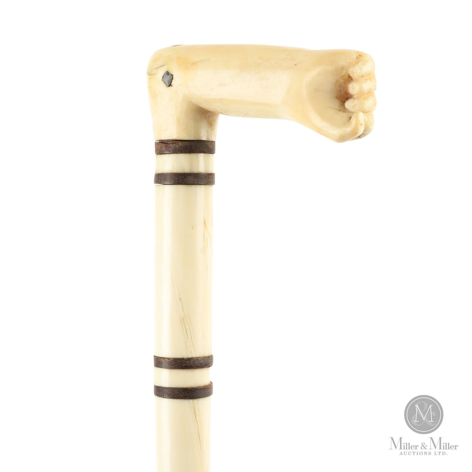Eastern Canadian Carved Narwhal Tusk Walking Stick: Canadian Maritimes. Mid-19th C. Made of marine ivory, baleen Narwhal tusk. The handle is carved in the form of a forearm with closed hand. Four baleen rings to the shaft. The shaft is carved with spir